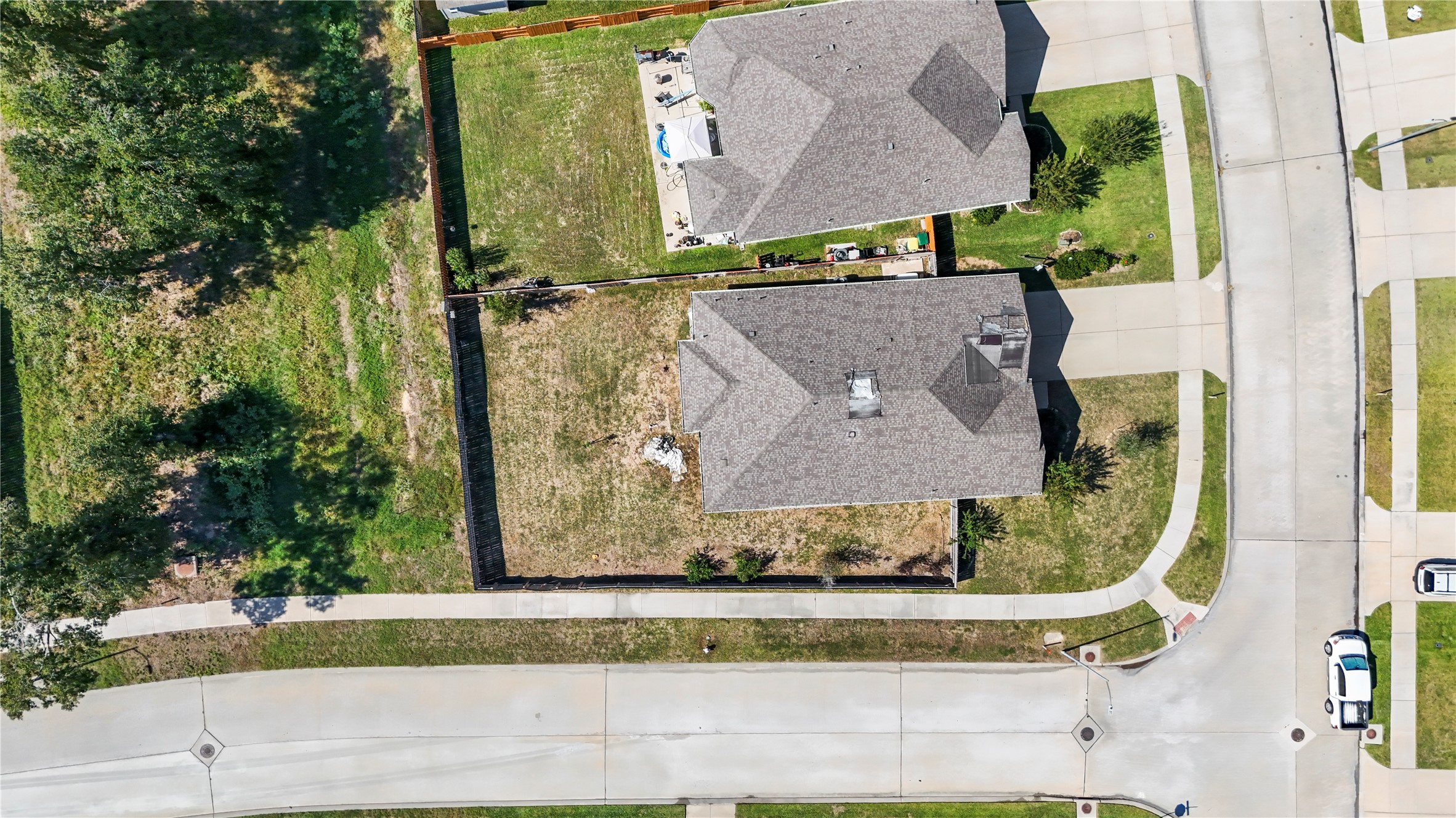 This corner lot not only gives you extra room but the backyard backs up to a green space with large trees.