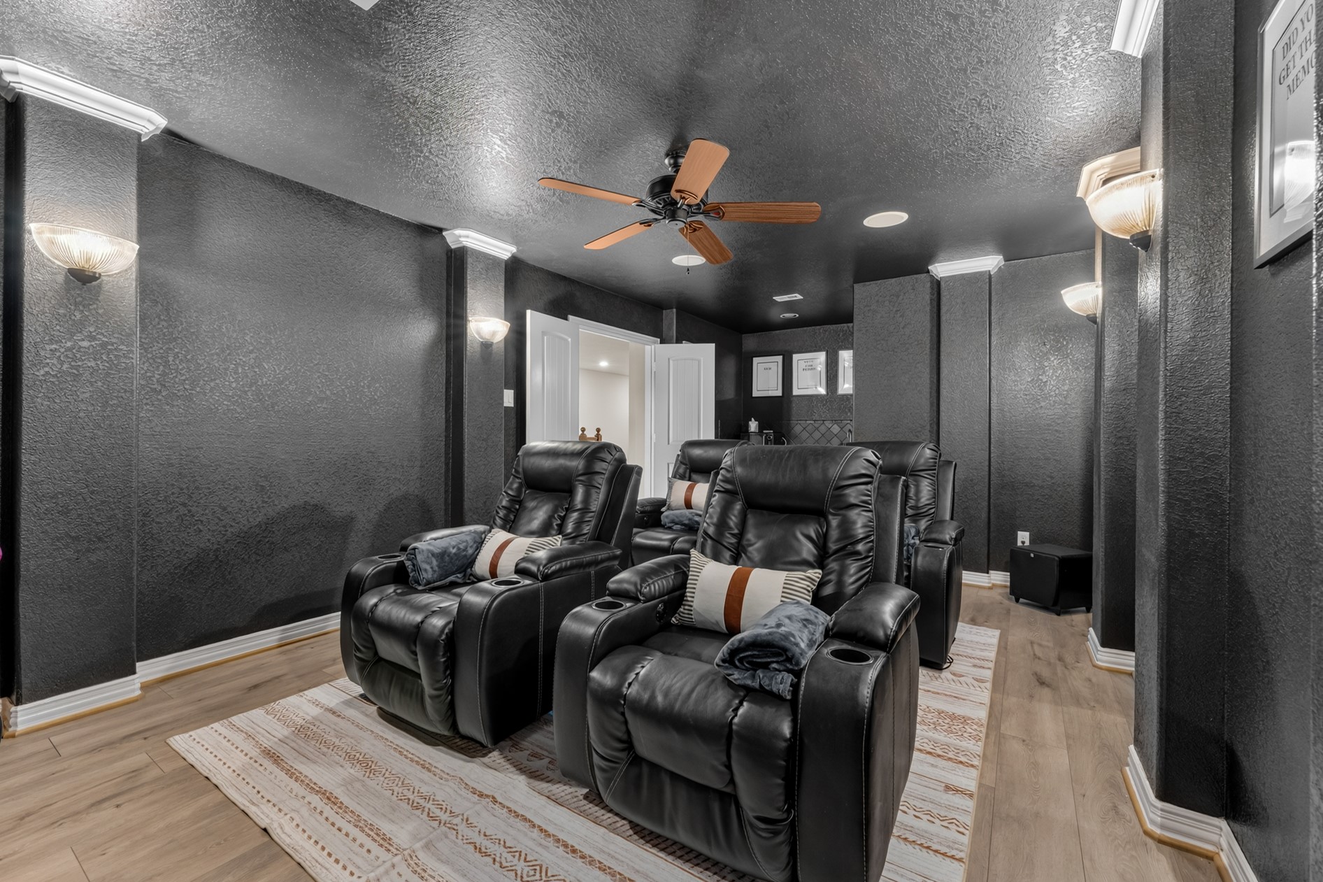 The four movie room chairs and the large-screen TV can stay with the house!