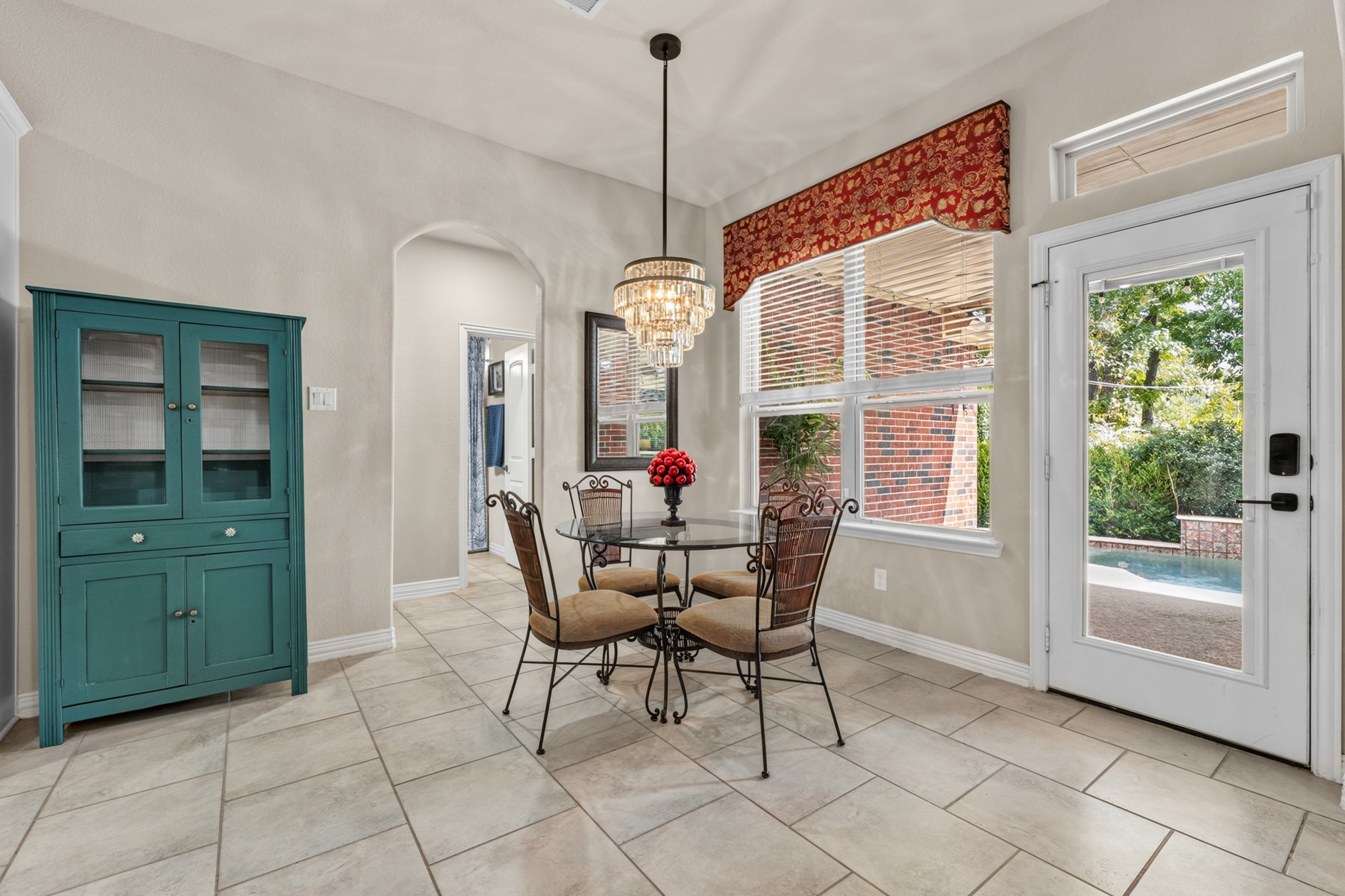 Access to the covered patio, pool, and backyard through the door on the right.  The doorway on the left leads to the third guest bedroom and bathroom.