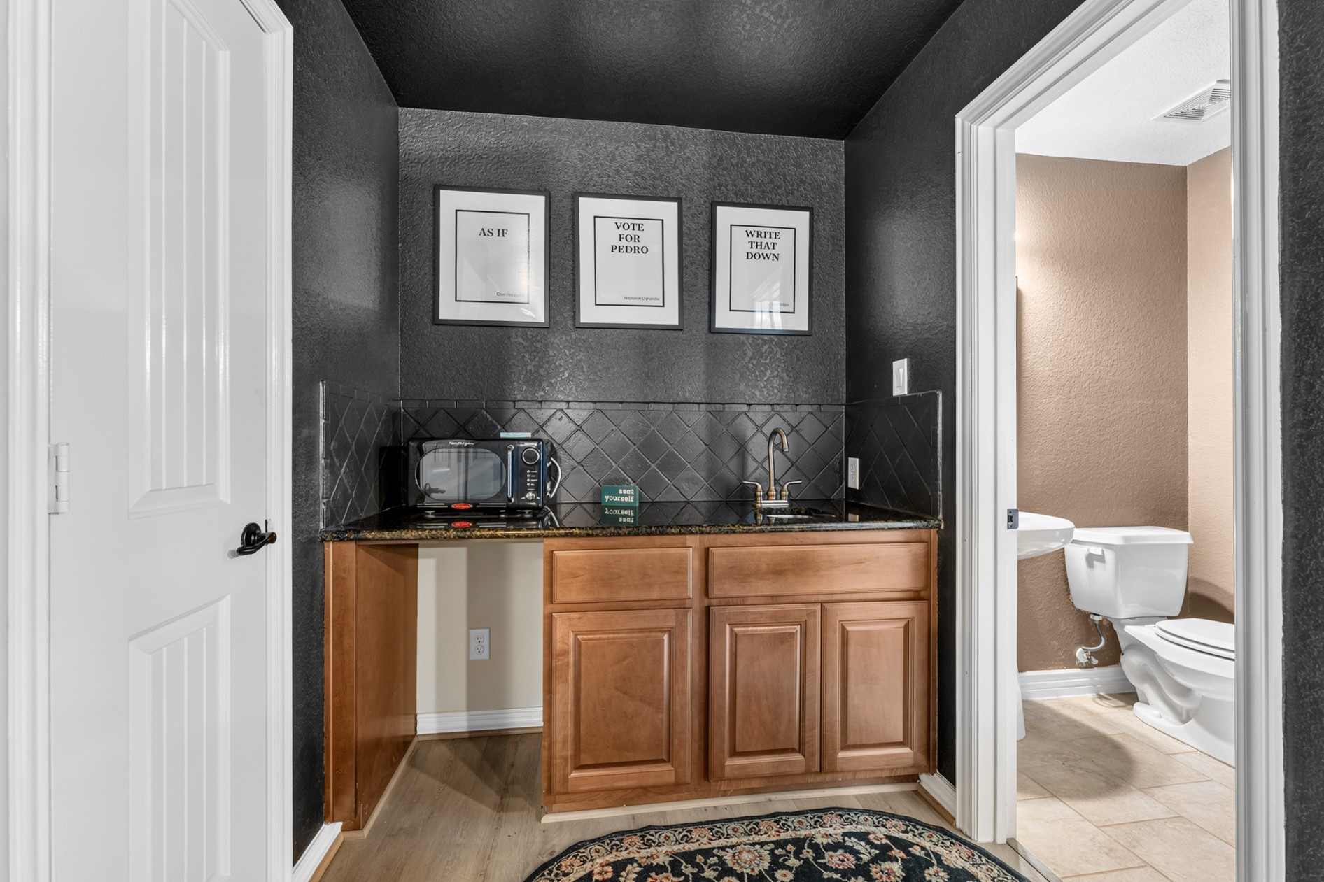 A wet bar area tucked in the back of the media room makes it easy to grab your favorite snacks and beverages!  There is also a half-bath!