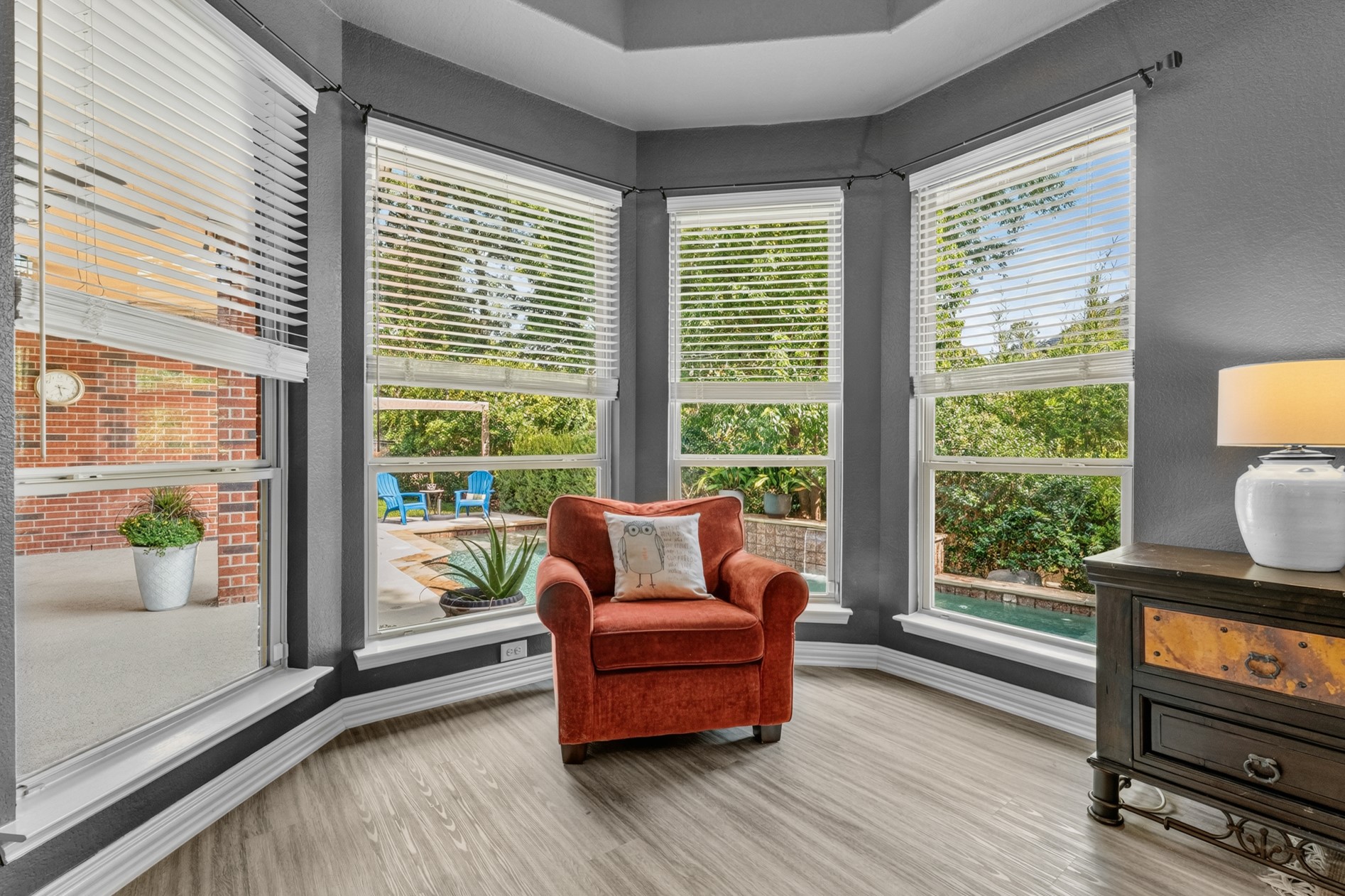 The sitting area is the perfect spot to take in the beauty of the sparkling pool and private backyard.