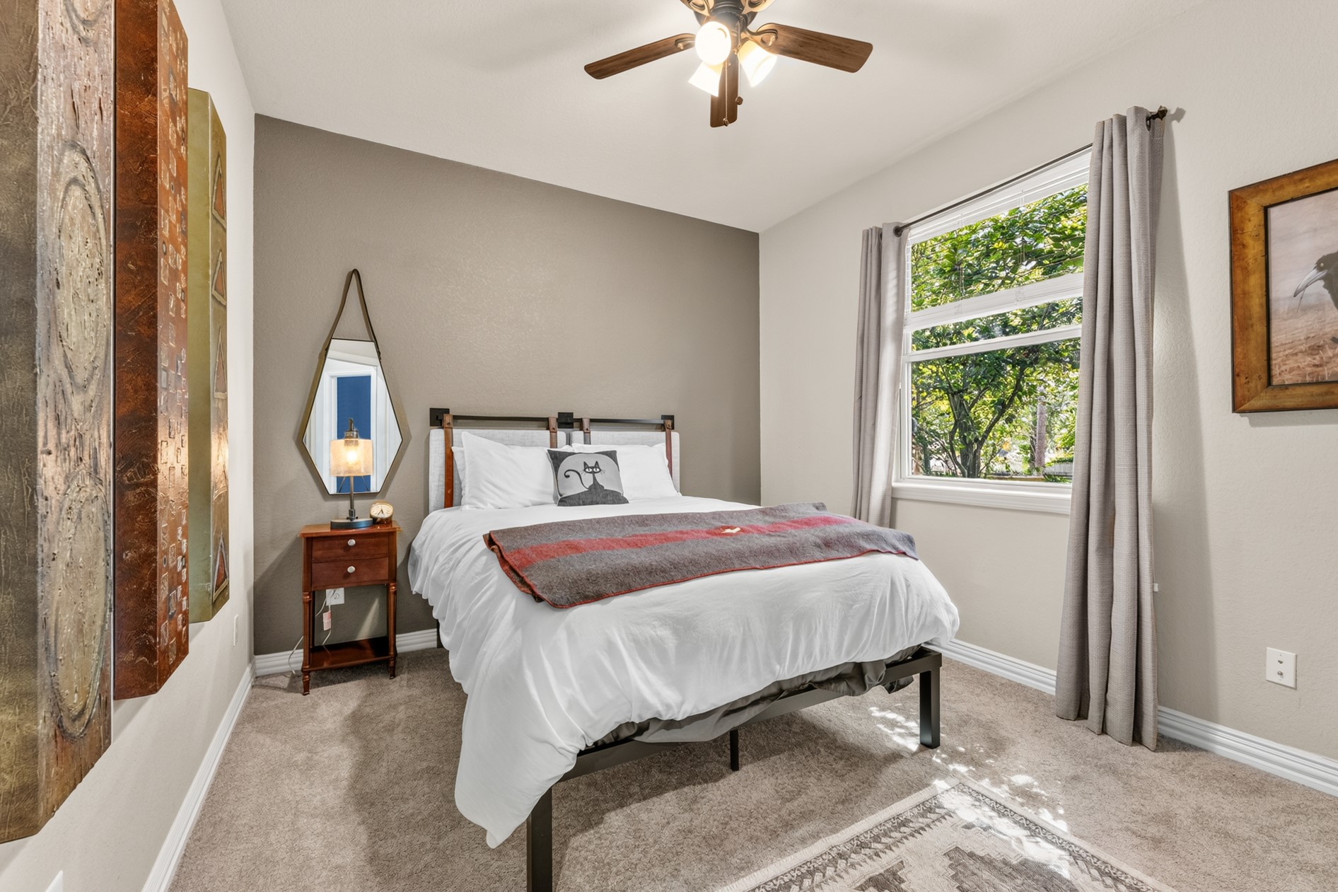 Sunny, second guest bedroom with a view of the park-like yard.