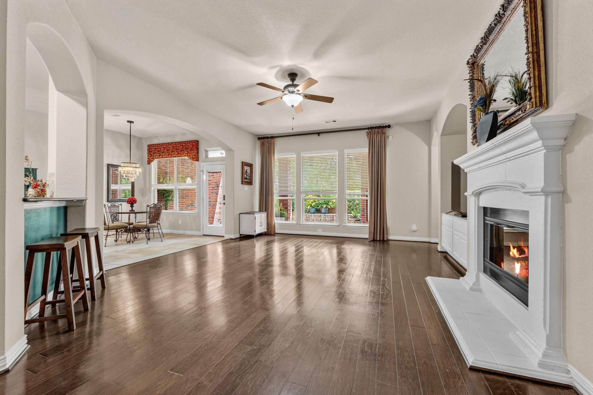 Back downstairs - This spacious living room is a great gathering spot!  Three large windows provide a view of the sparkling pool!