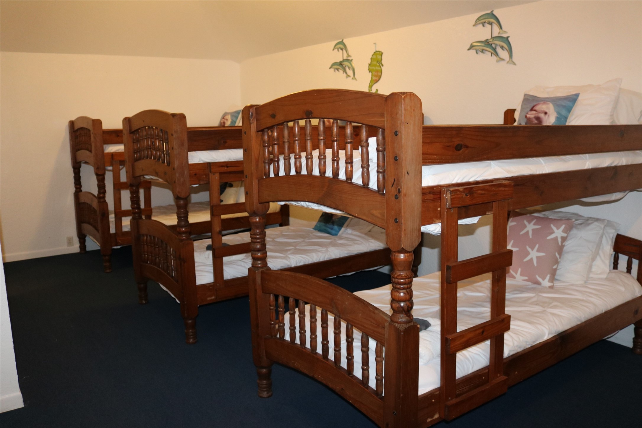 The third-level guest room features three sets of durable wooden bunk beds, perfect for accommodating multiple guests comfortably.