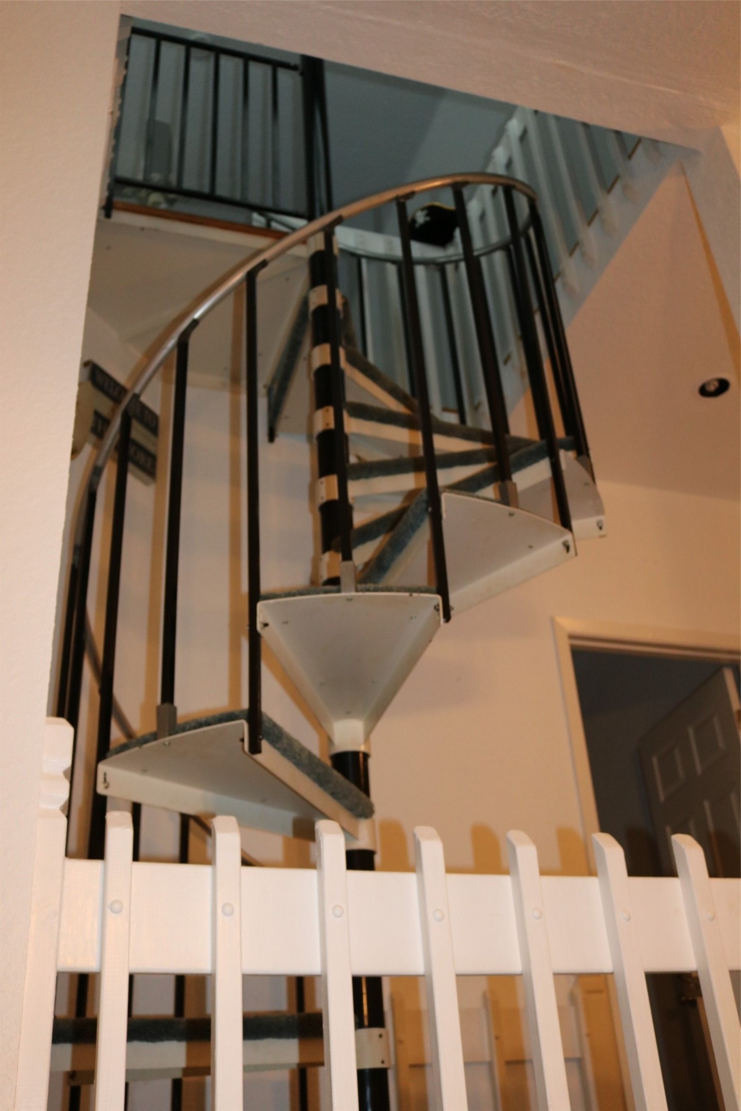 Spiral staircase ascending to the third level and guest room.