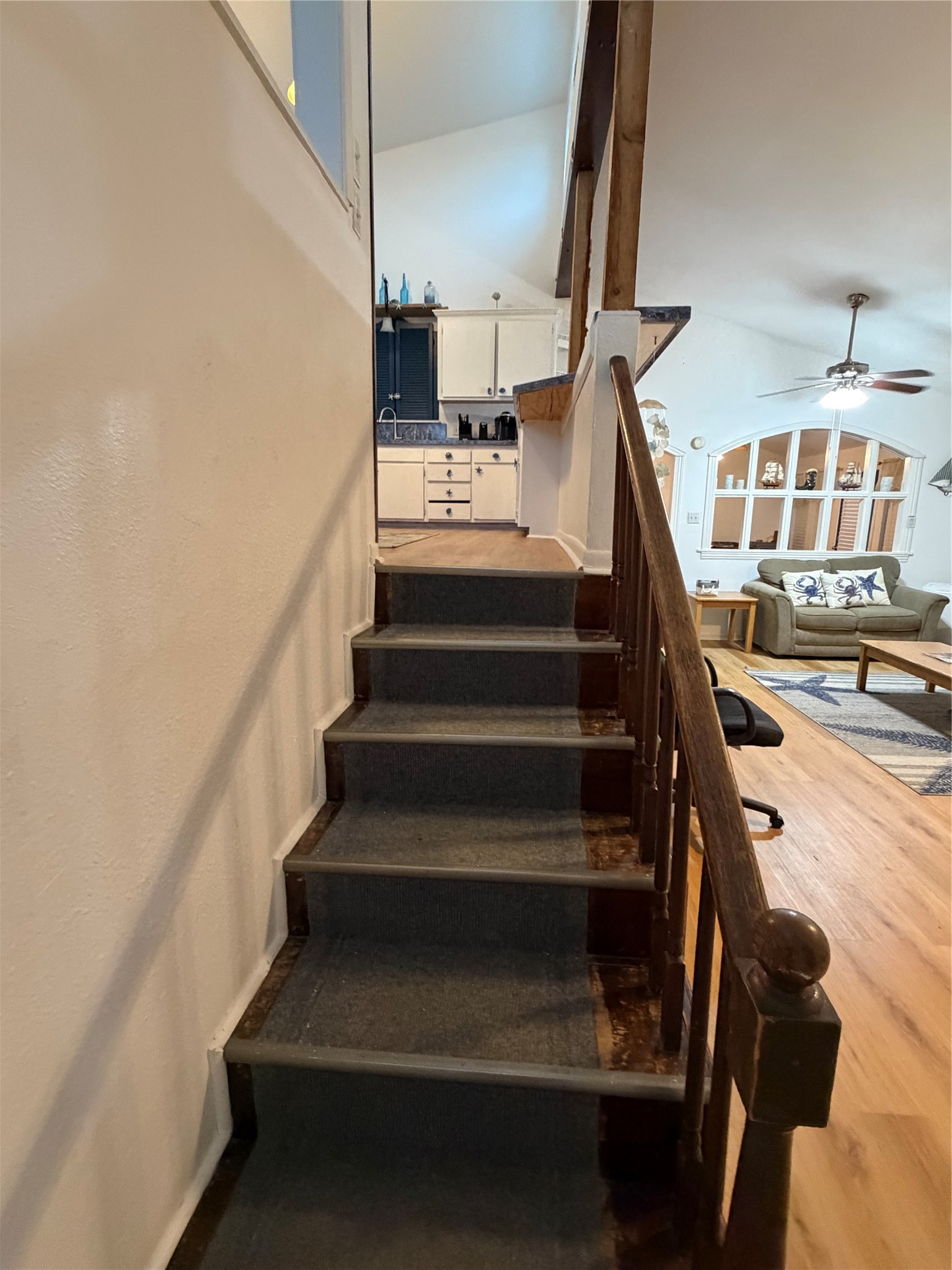 Seamlessly transition from the cozy family room to the inviting kitchen with these convenient stairs.