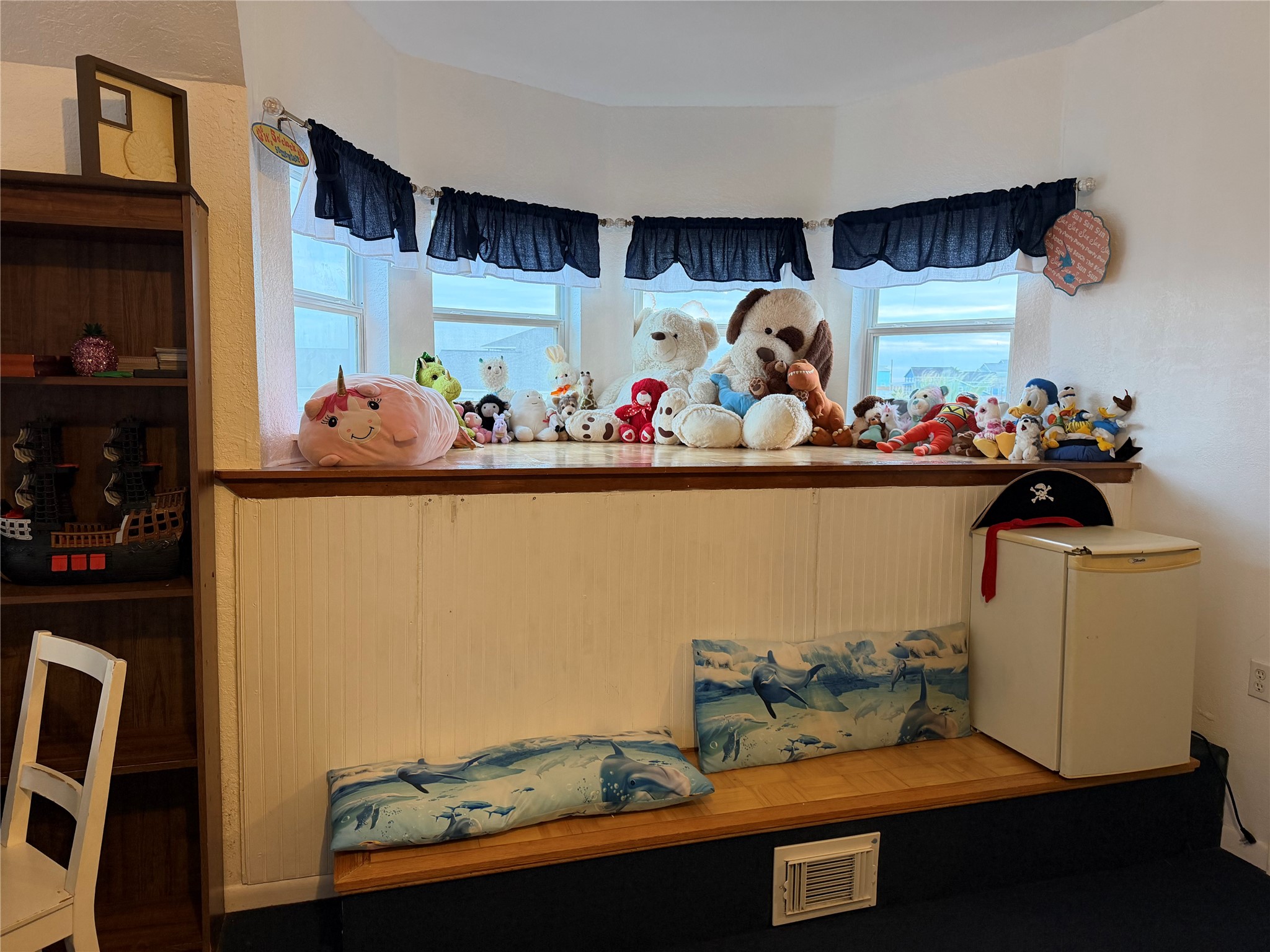Charming bay window nook in the third-level guest room offers stunning views of the gulf and swim beach.