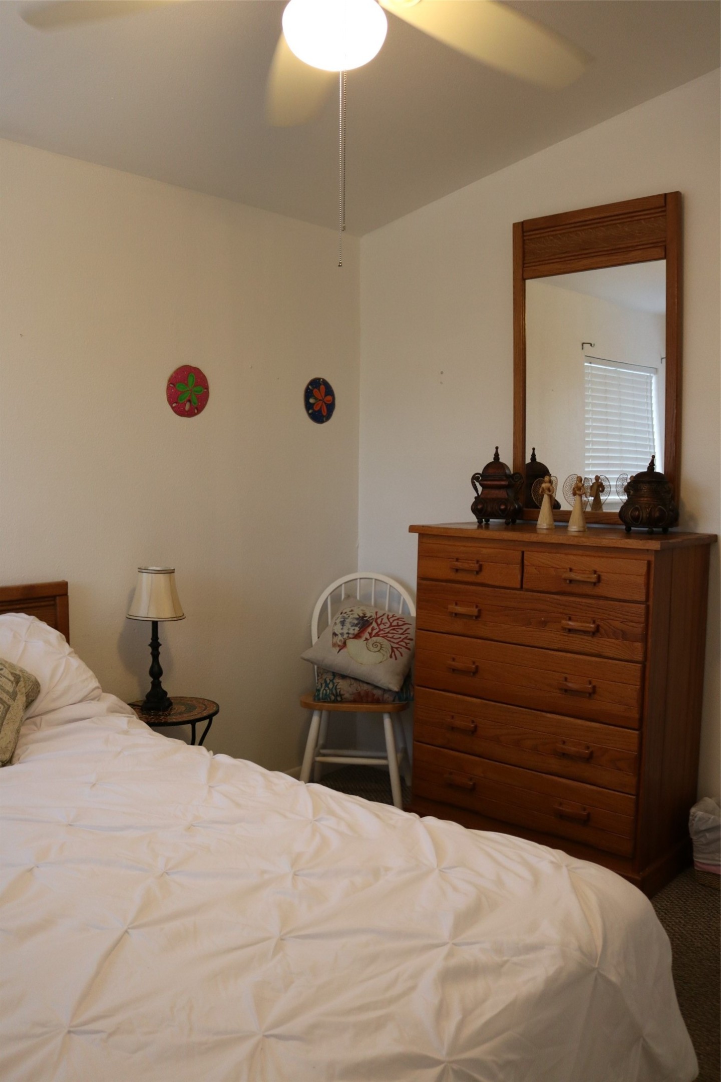 Cozy guest room featuring a comfortable queen-size bed and ample storage with a stylish dresser.