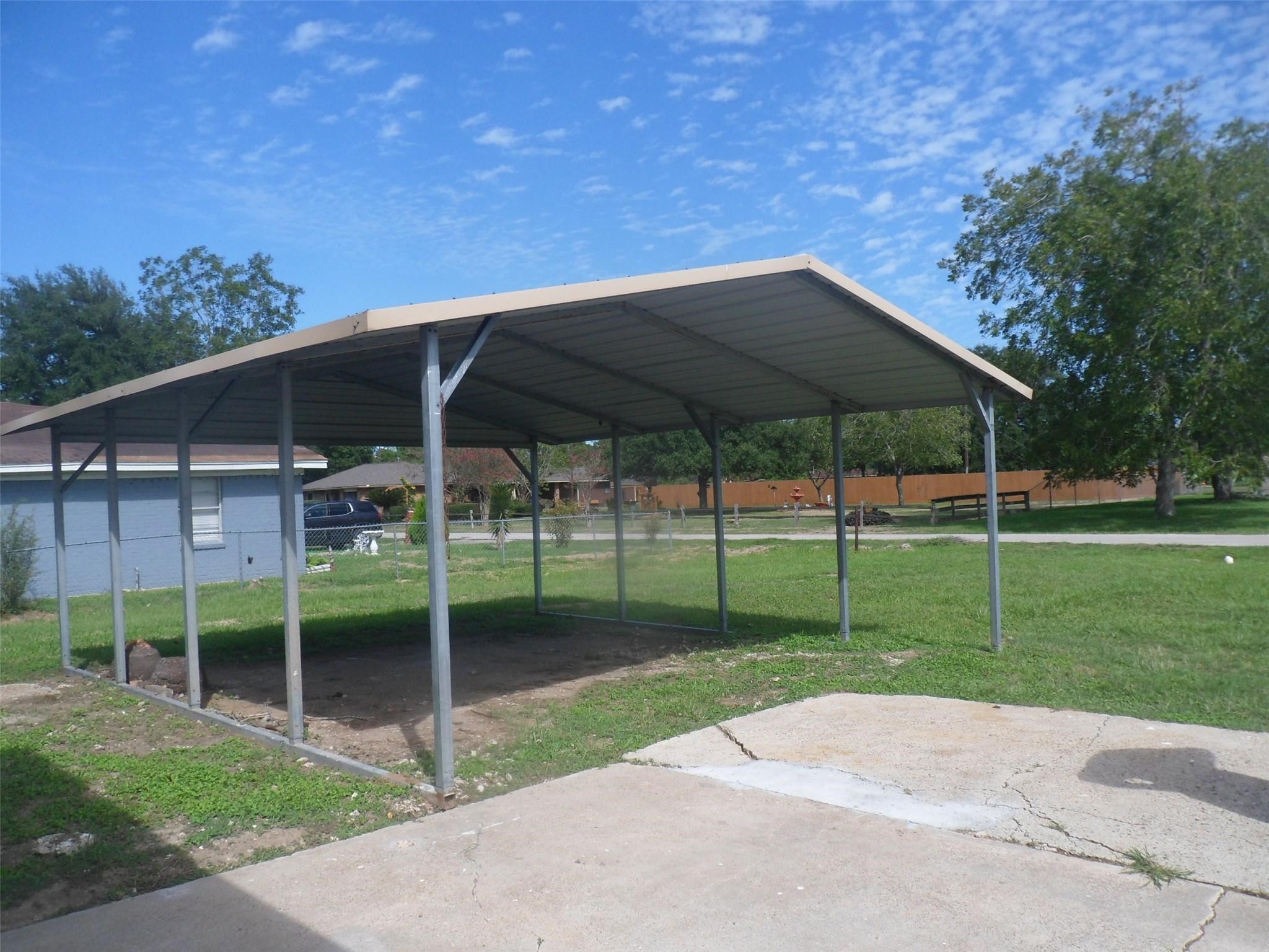 Spacious 2-car carport offers convenient and sheltered parking, enhancing your home's functionality and curb appeal. Spacious 2-car carport offers convenient and sheltered parking, enhancing your home's functionality and curb appeal.