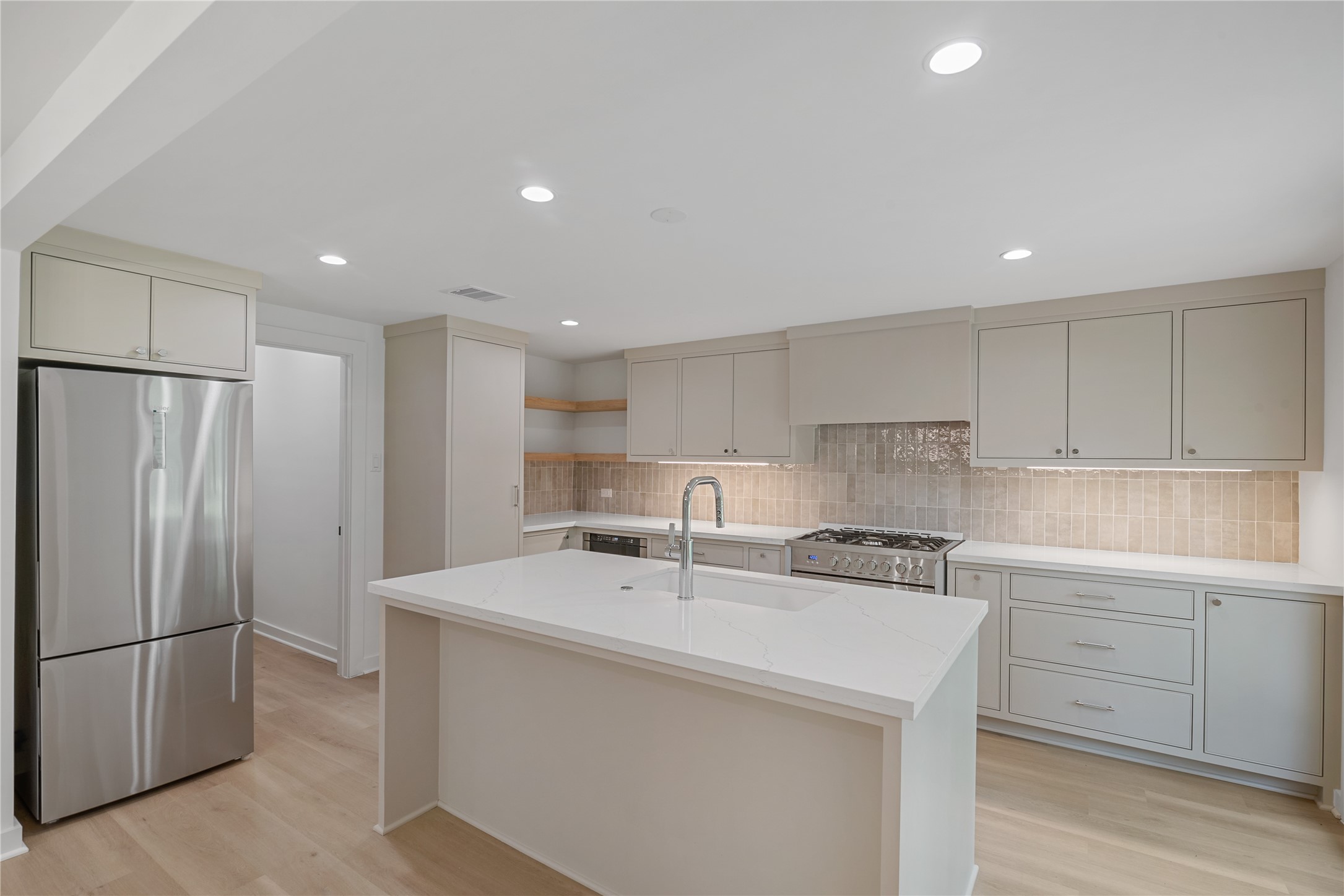 Spacious kitchen offers generous counter space, an oversized island, modern cabinetry, and a bright, open layout. Spacious kitchen offers generous counter space, an oversized island, modern cabinetry, and a bright, open layout.