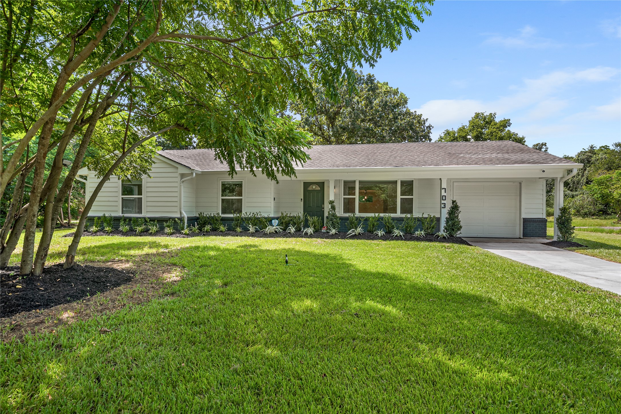 Inviting front exterior showcasing the home's refreshed appearance, mature landscaping, and spacious front lawn. Inviting front exterior showcasing the home's refreshed appearance, mature landscaping, and spacious front lawn.