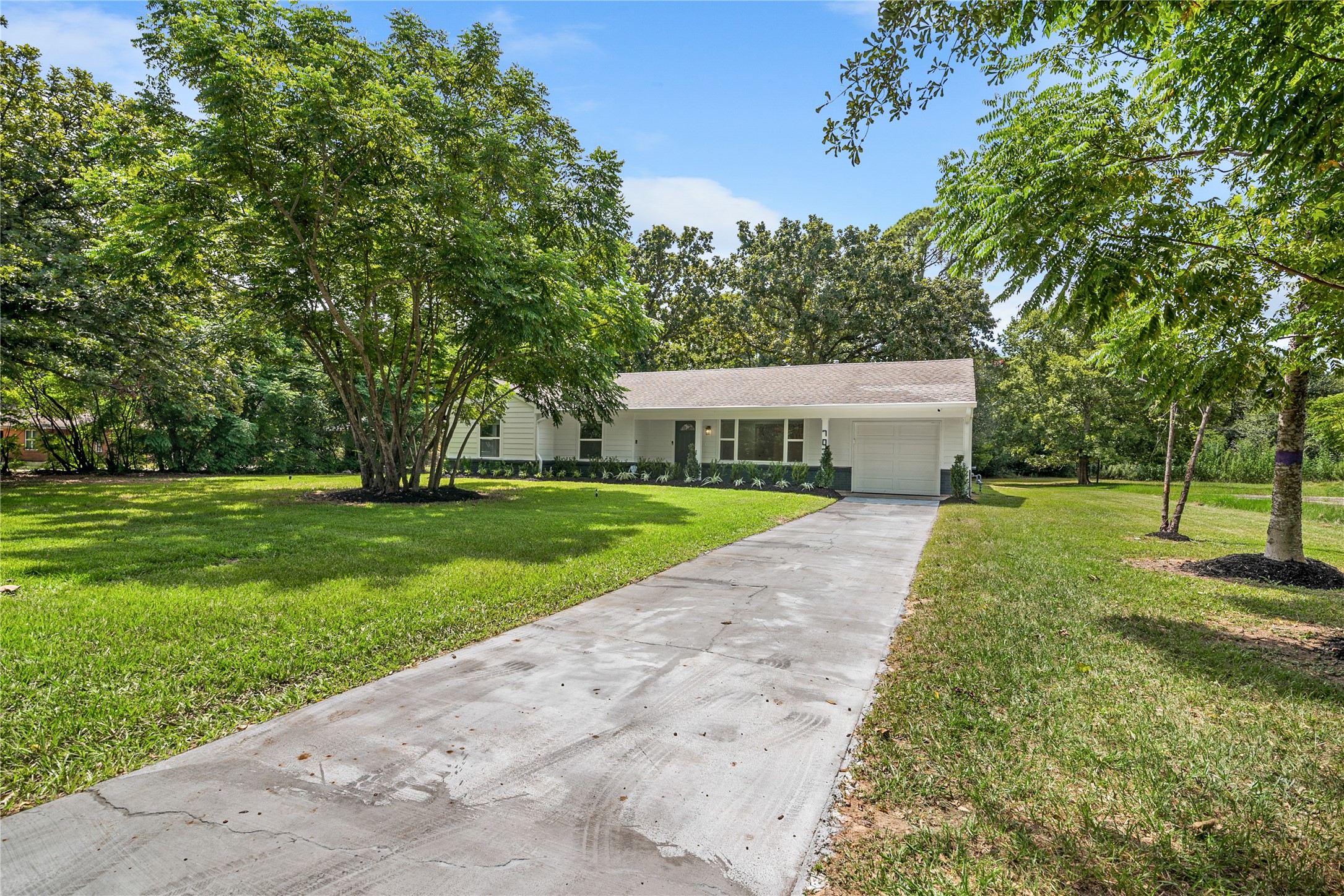 Long driveway leads to the home through a beautifully shaded property with mature trees and abundant green space. Long driveway leads to the home through a beautifully shaded property with mature trees and abundant green space.