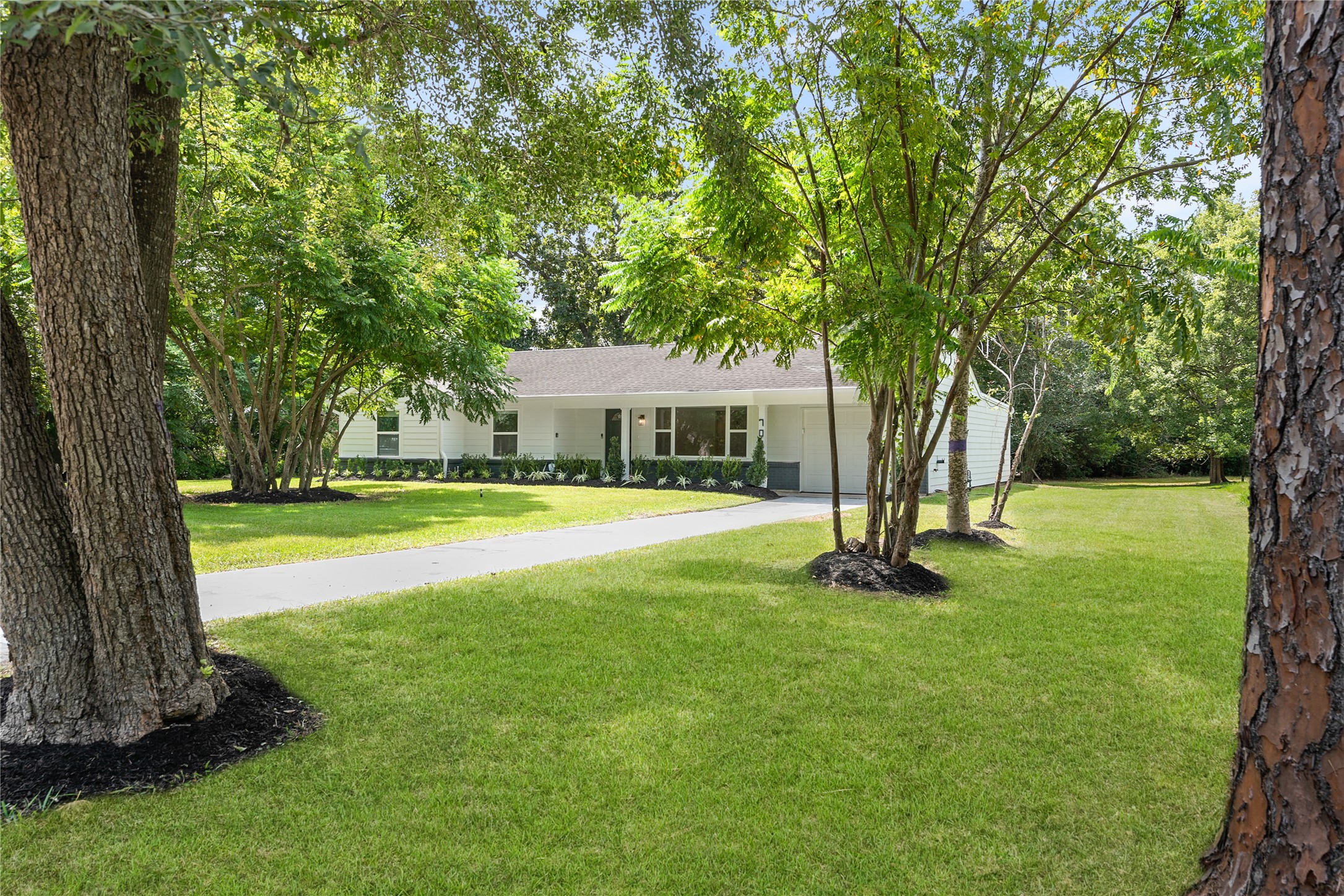 Mature shade trees frame the welcoming approach to the home, offering an attractive setting with plenty of outdoor space. Mature shade trees frame the welcoming approach to the home, offering an attractive setting with plenty of outdoor space.