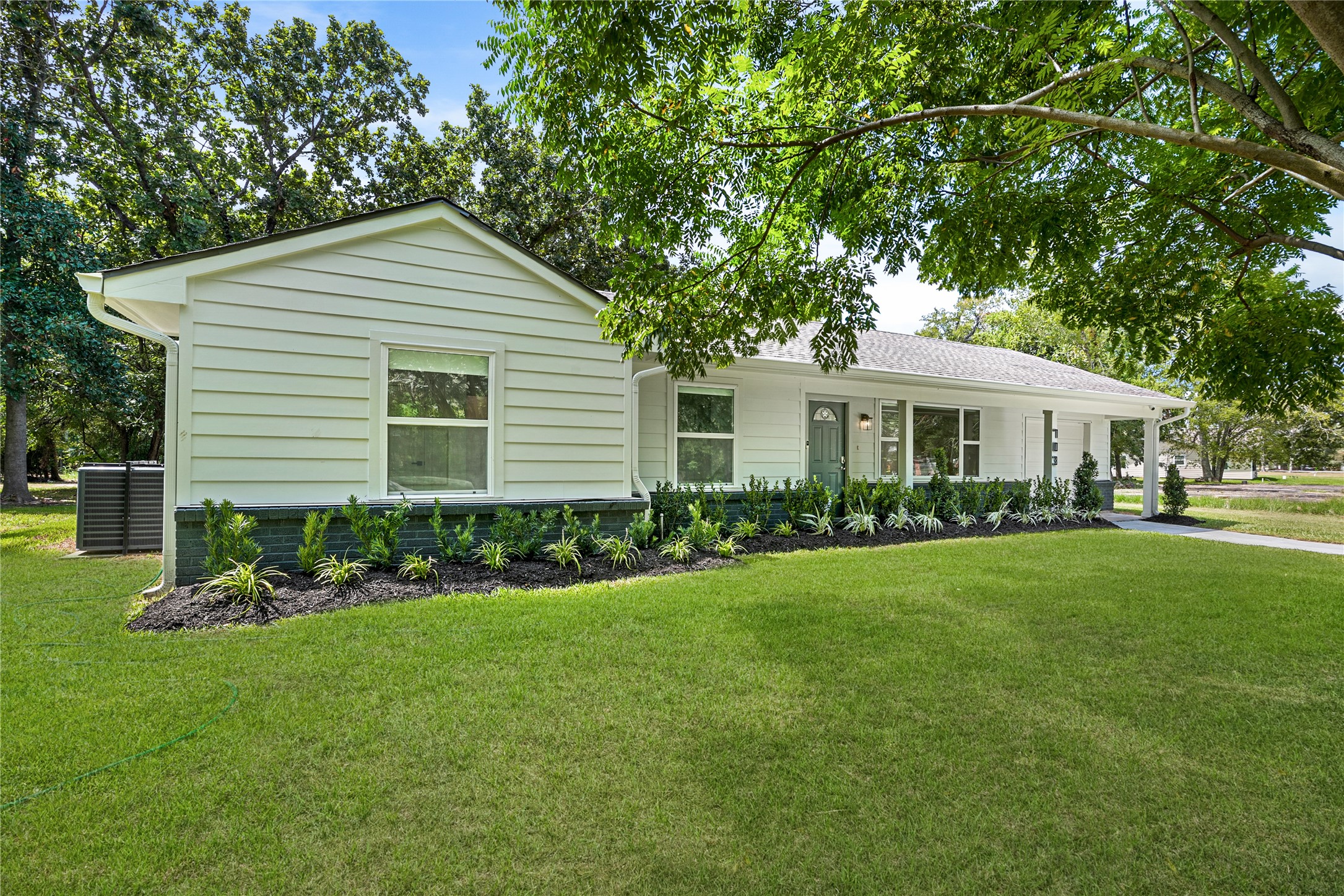 Beautifully renovated 4-bedroom, 3-bath ranch-style home situated on nearly an acre in Richmond, surrounded by mature trees and expansive green space.