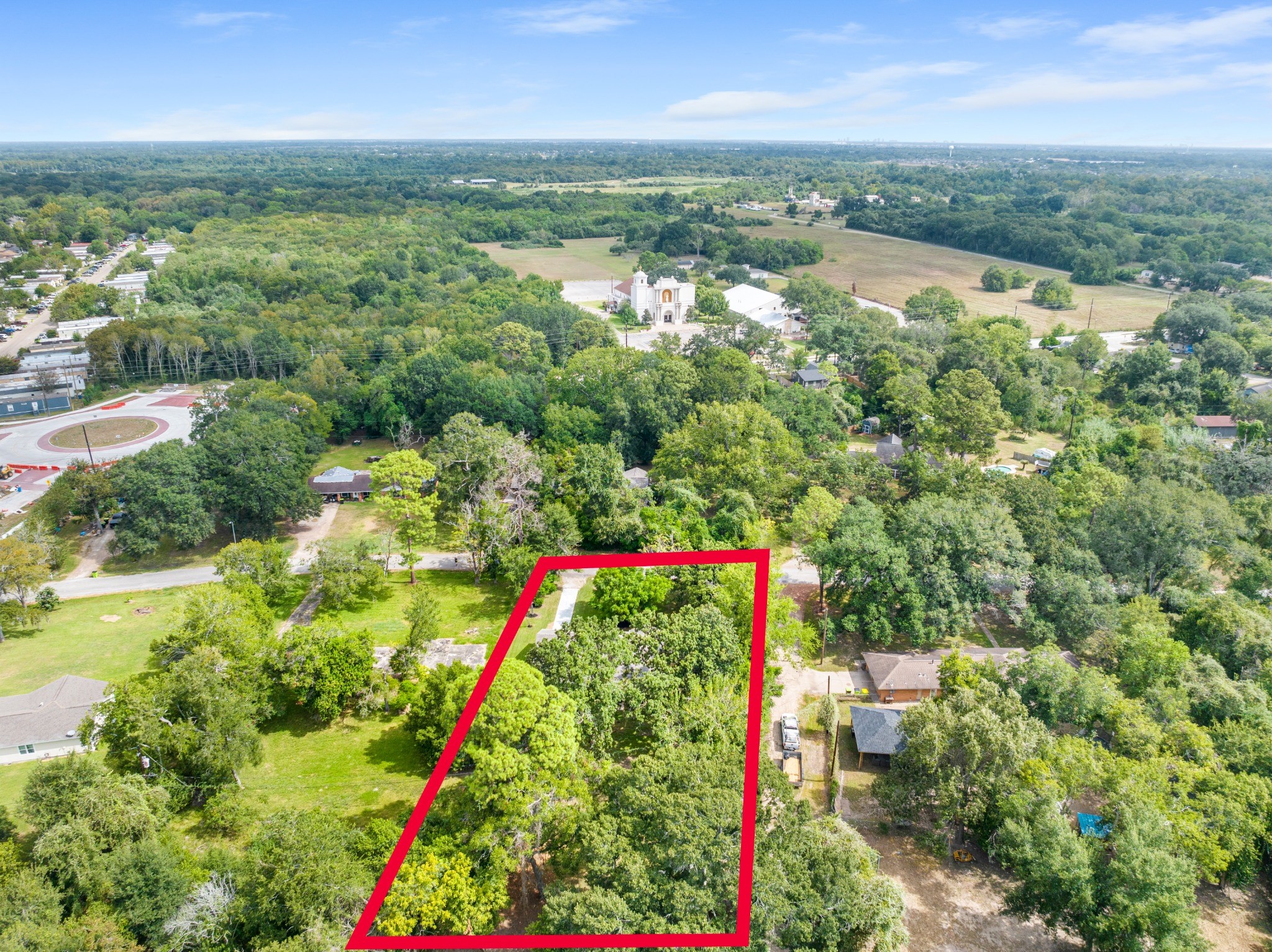 Elevated aerial perspective with approximate property boundaries marked in red, showcasing the property's generous lot dimensions.