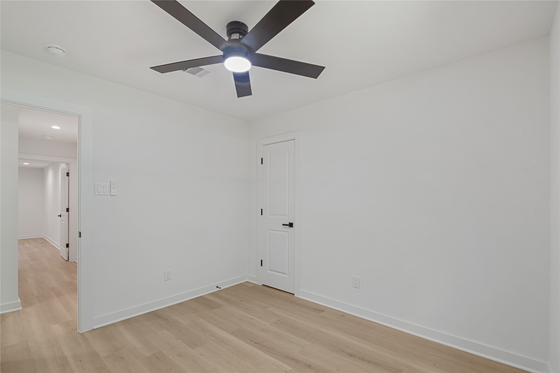 Additional bedroom featuring updated flooring, neutral walls, and a contemporary ceiling fan.