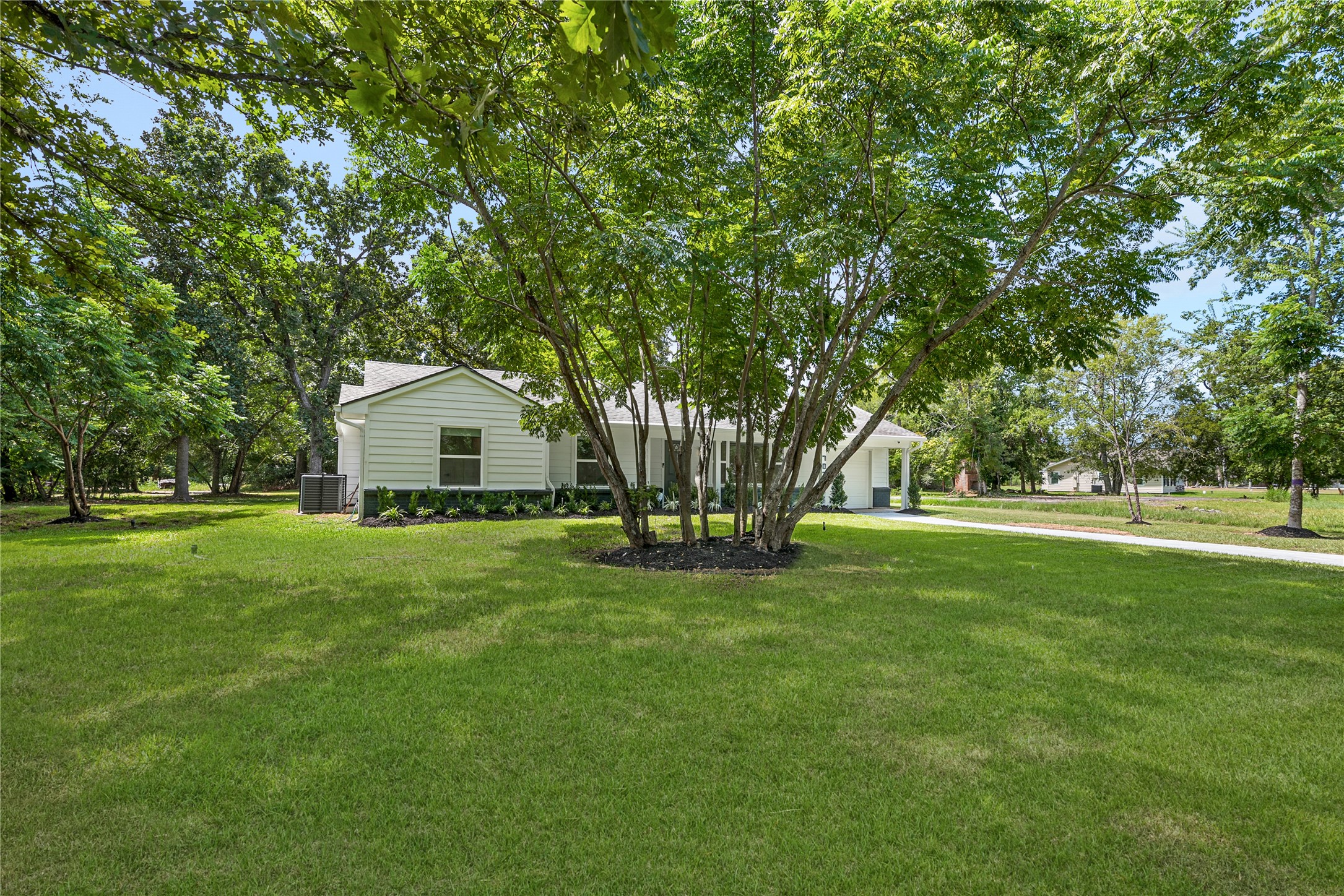 Expansive, tree-lined front lawn highlights the generous lot size and peaceful, established surroundings. Expansive, tree-lined front lawn highlights the generous lot size and peaceful, established surroundings.