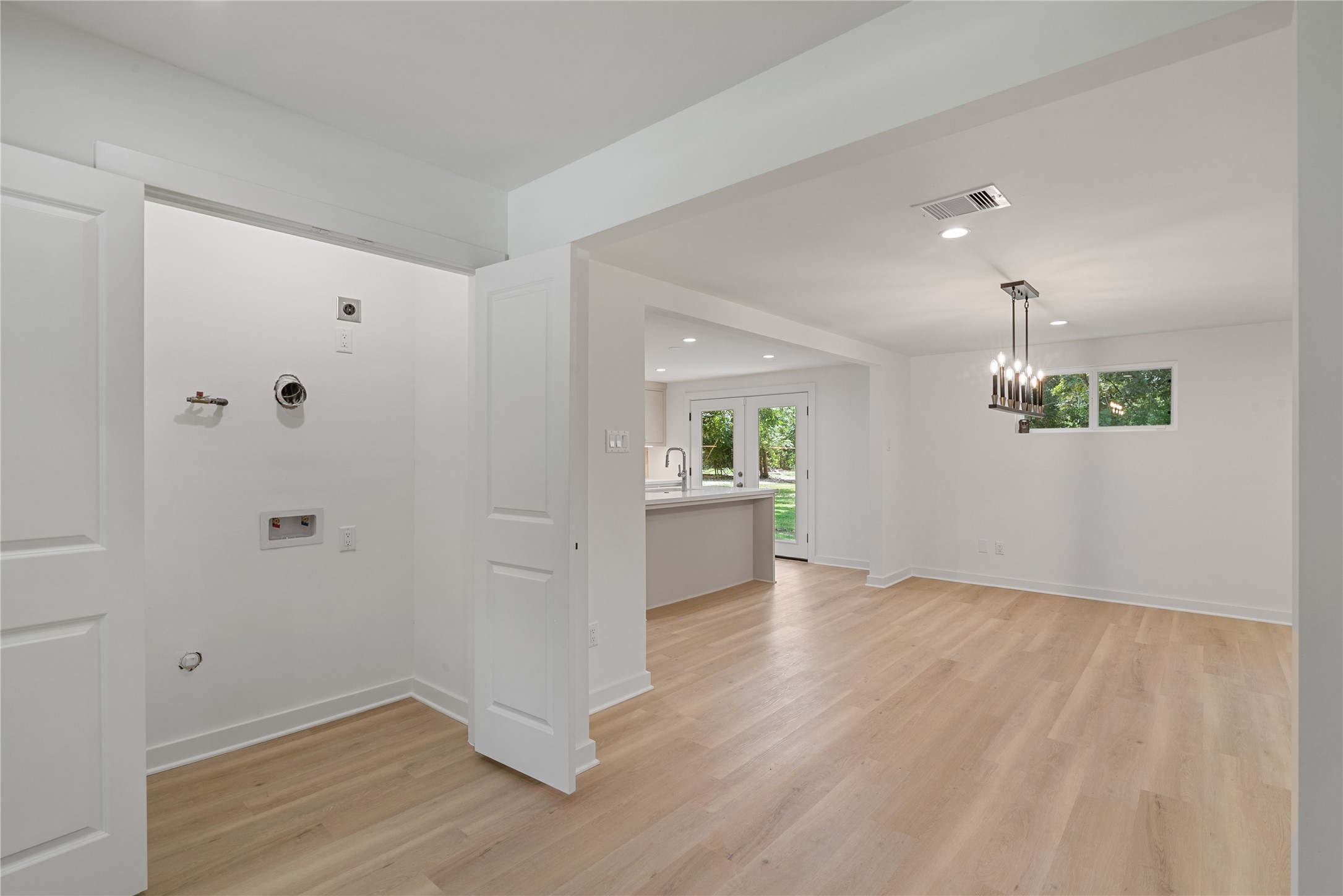 Bright interior passage with updated flooring, recessed lighting, and a seamless transition between rooms.