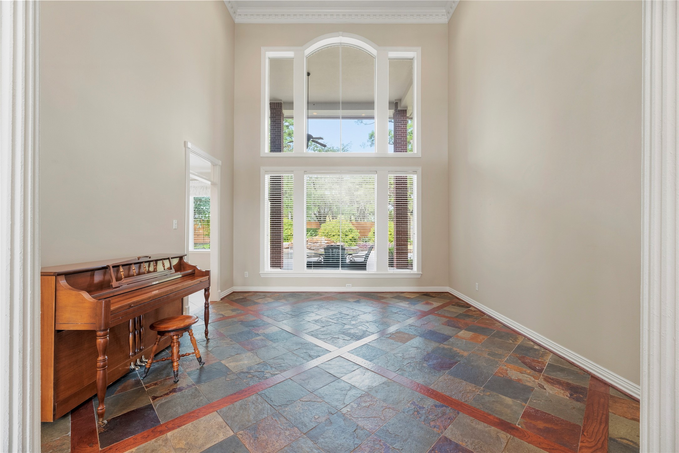 Another view of the formal living room with a wall of windows and wonderful backyard views.