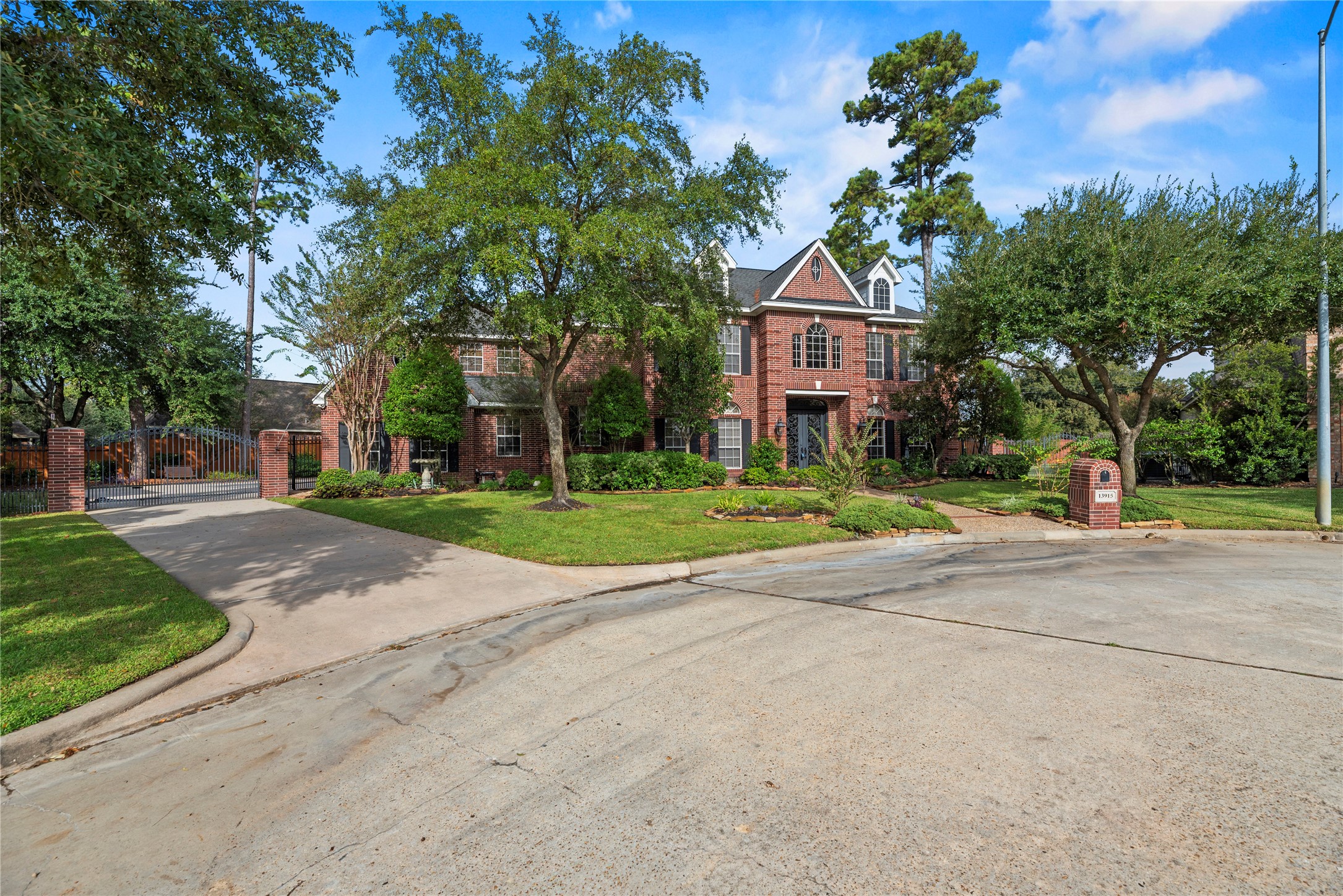 Huge lot with a gated driveway leading to an attached 3-car garage.