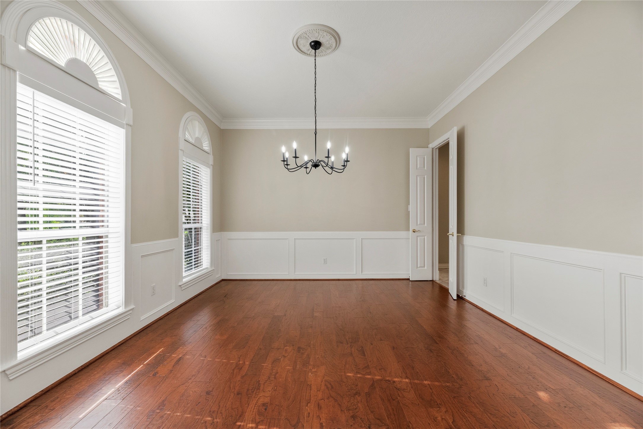 Enjoy elegant gatherings in this lovely formal dining room with hardwood flooring.