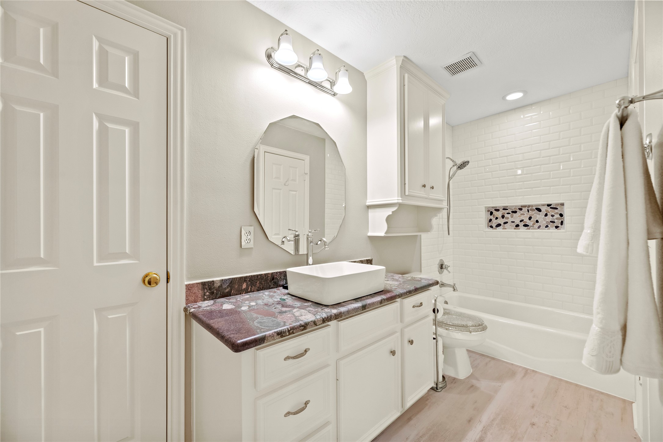 En-suite upstairs bathroom with a tub/shower combination.