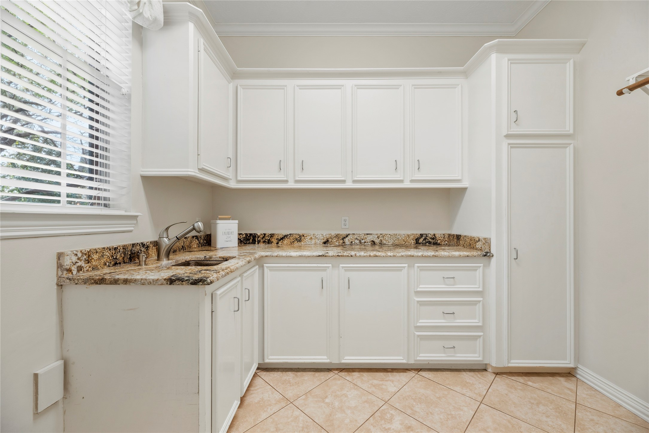 Downstairs utility room has a sink and additional storage.