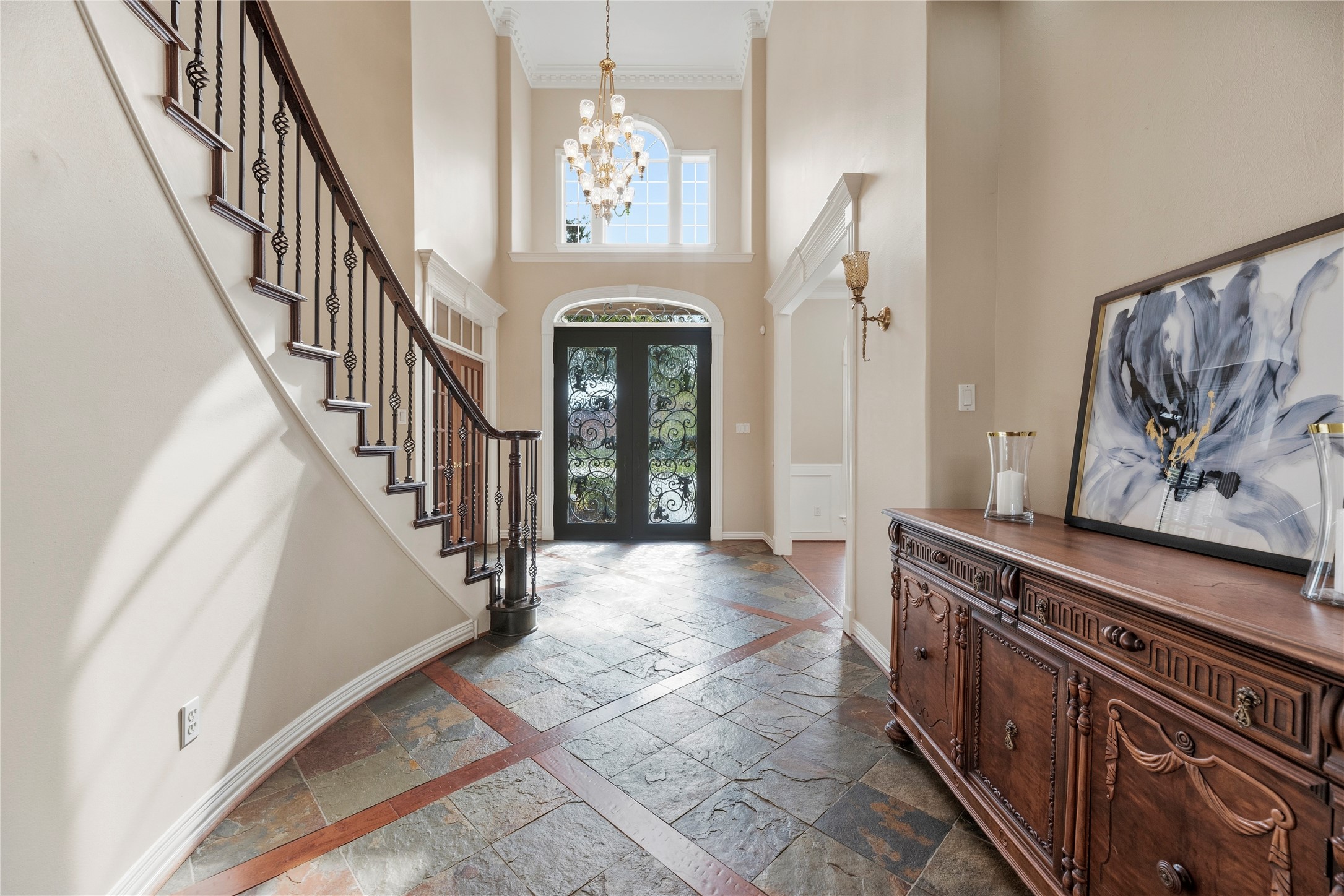 Beautiful slate flooring, transom windows, soaring ceilings, intricate trim work and an elegant chandelier.