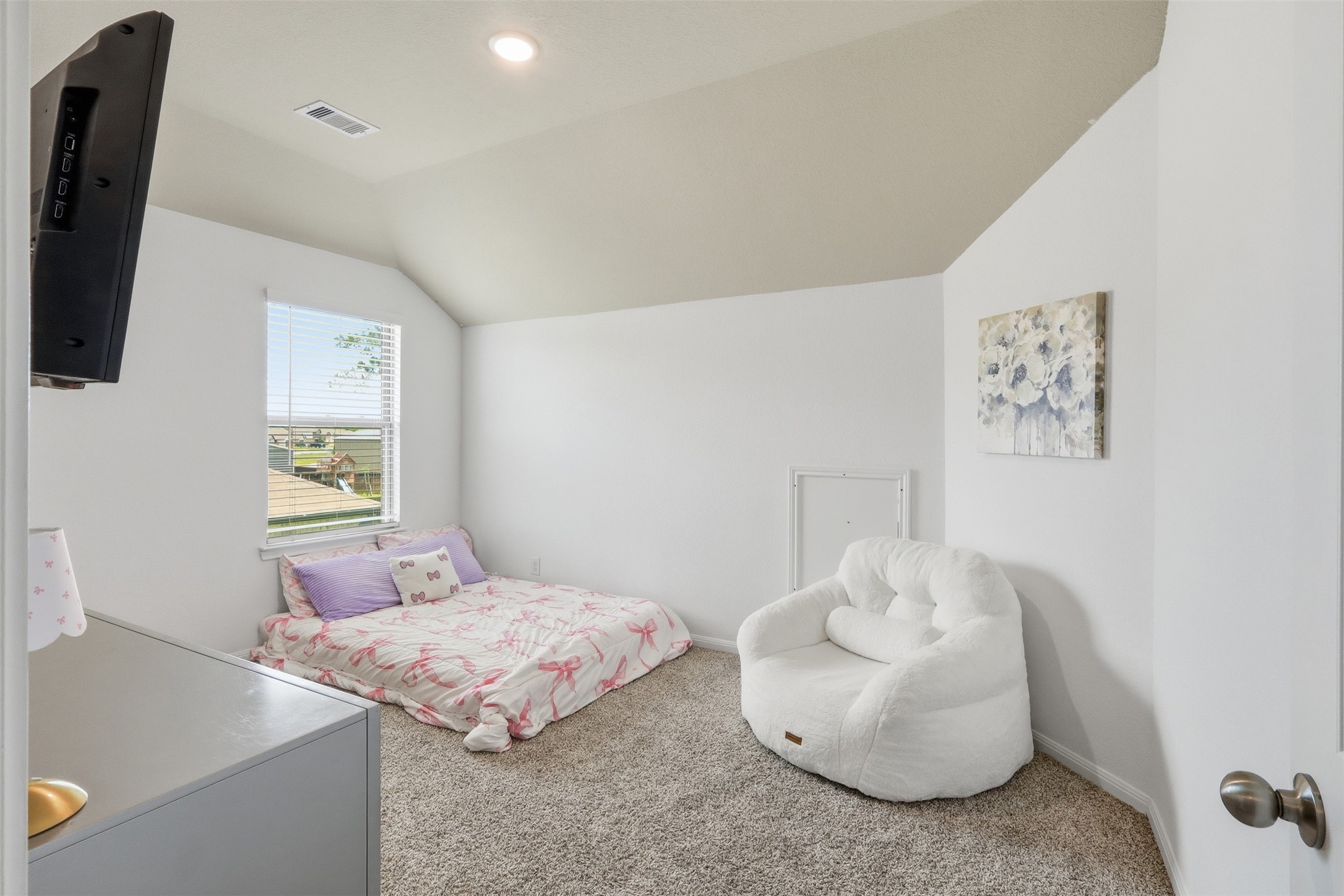 Spacious upstairs secondary bedroom featuring neutral designer colors, abundant natural light, and a versatile layout to fit any lifestyle.