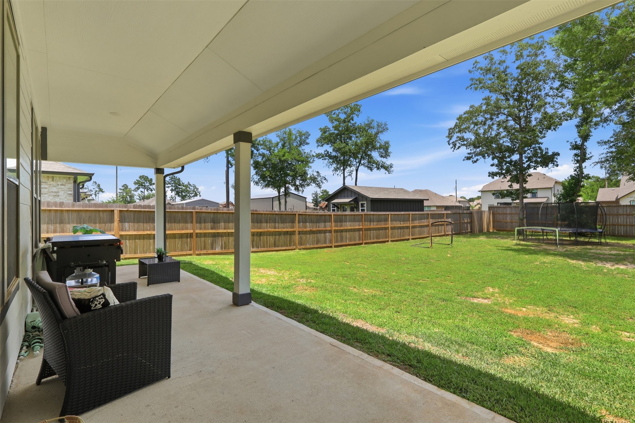 Expansive backyard featuring an oversized covered patio, plenty of green space, and a fenced yardperfect for entertaining, relaxing, or creating your dream outdoor oasis.