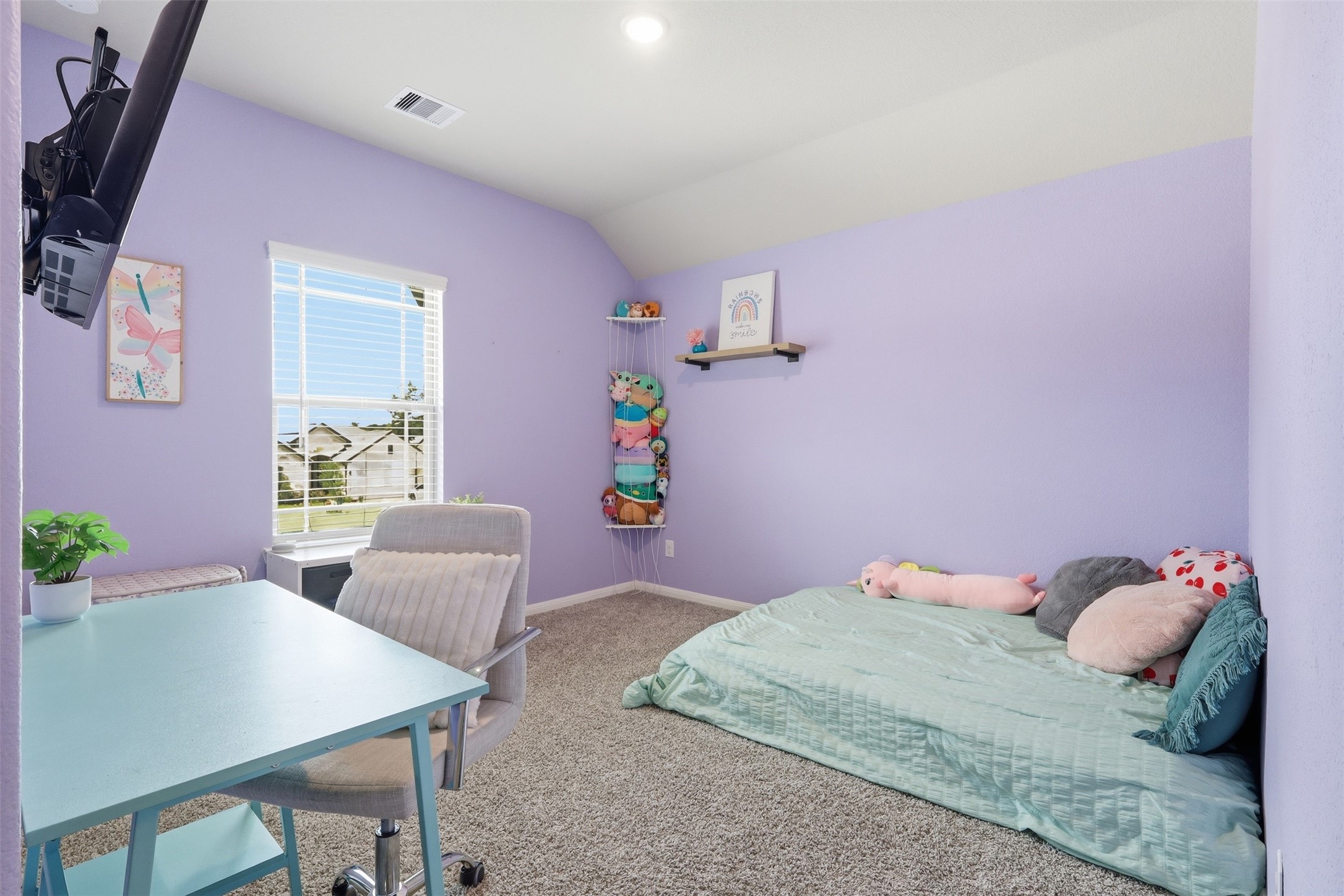 Generously sized upstairs secondary bedroom featuring ample space, natural light, and easy access to the game room and media room.