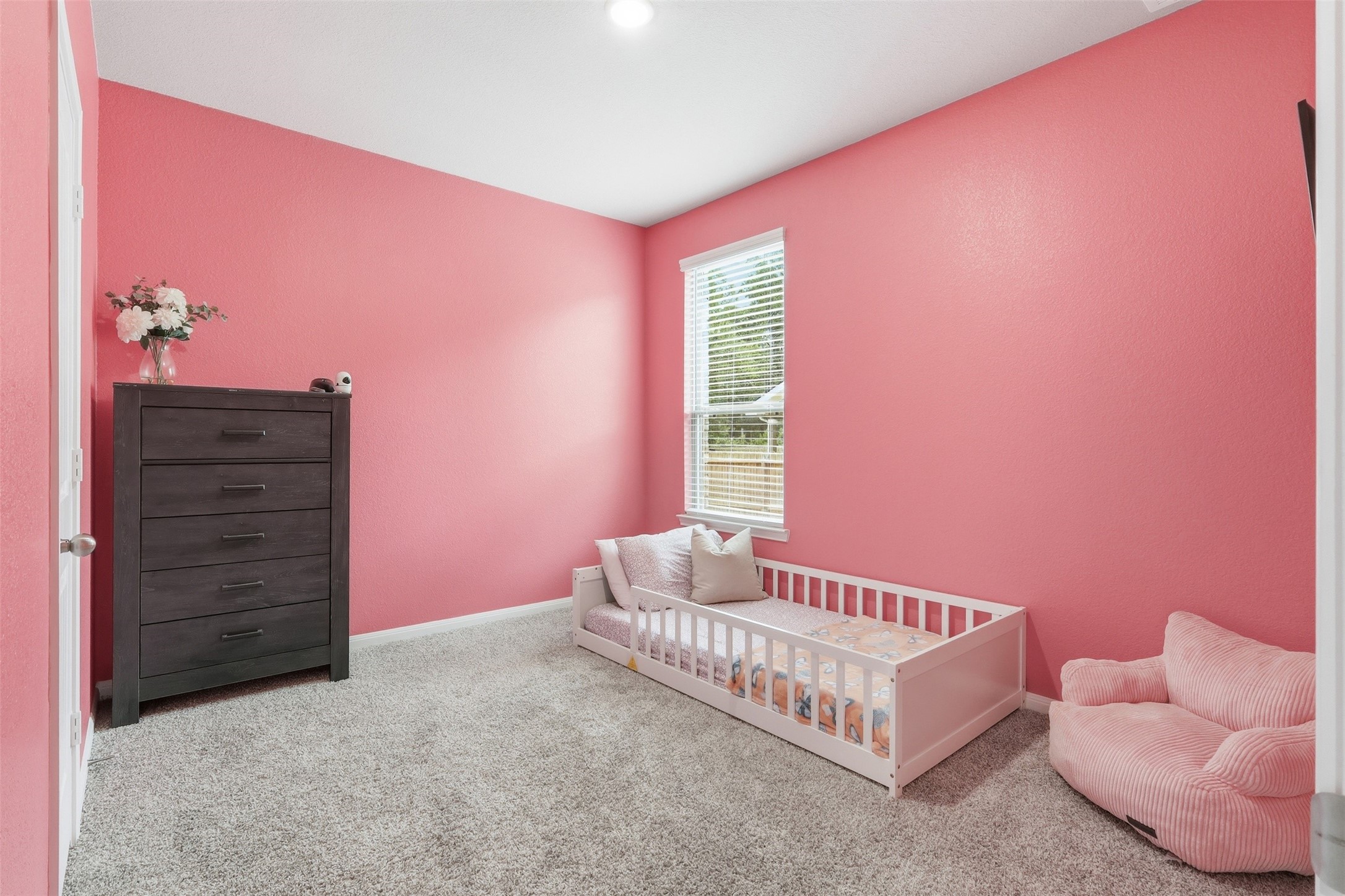 Spacious first-floor secondary bedroom conveniently located next to a full bathroom, ideal for guests or multigenerational living.