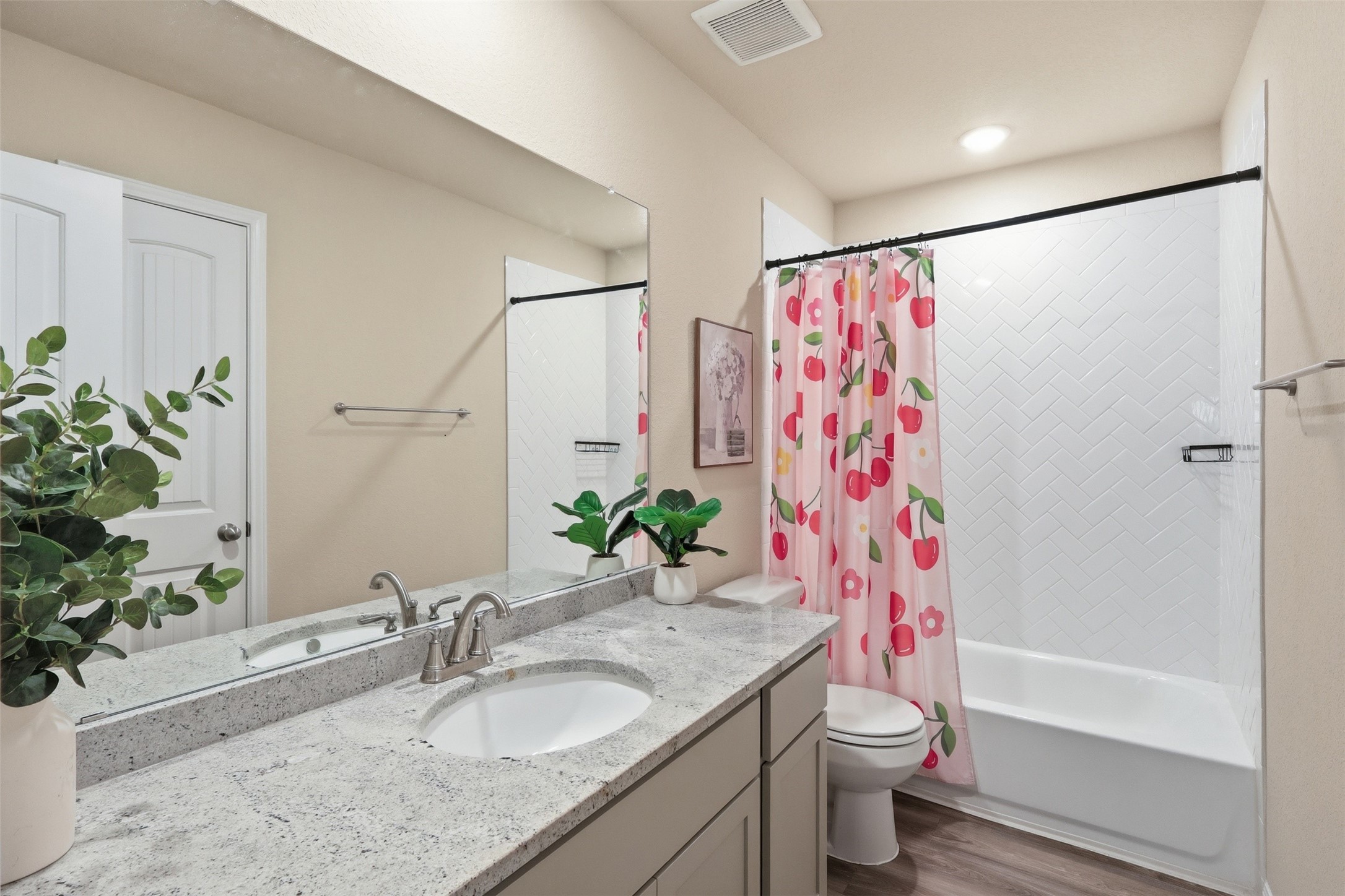 Bright upstairs full bathroom featuring an oversized granite vanity with ample countertop space, a linen closet for added storage, and modern finishes throughout.