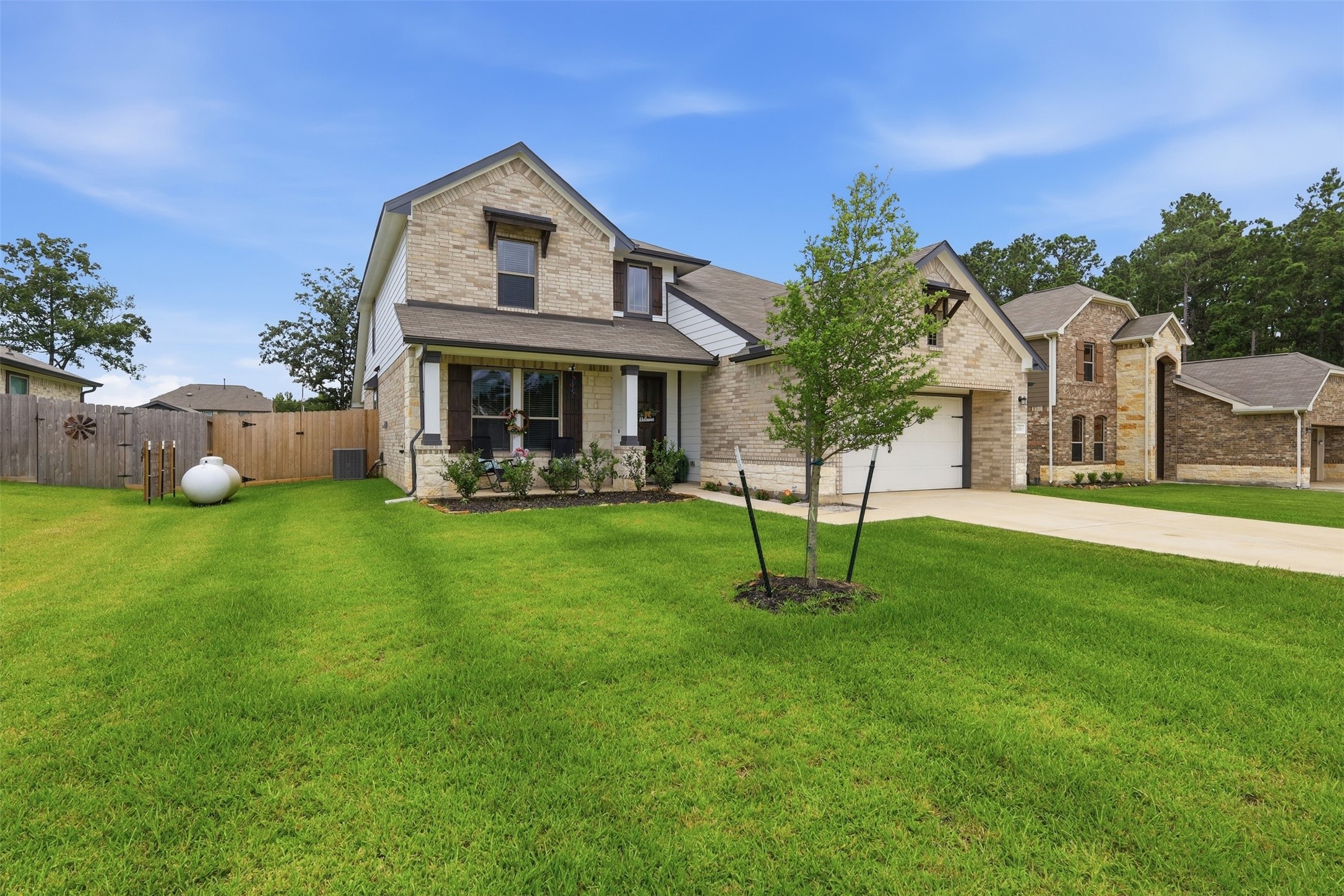 Beautiful curb appeal with attractive brick-and-stone construction and a well-maintained lawn.