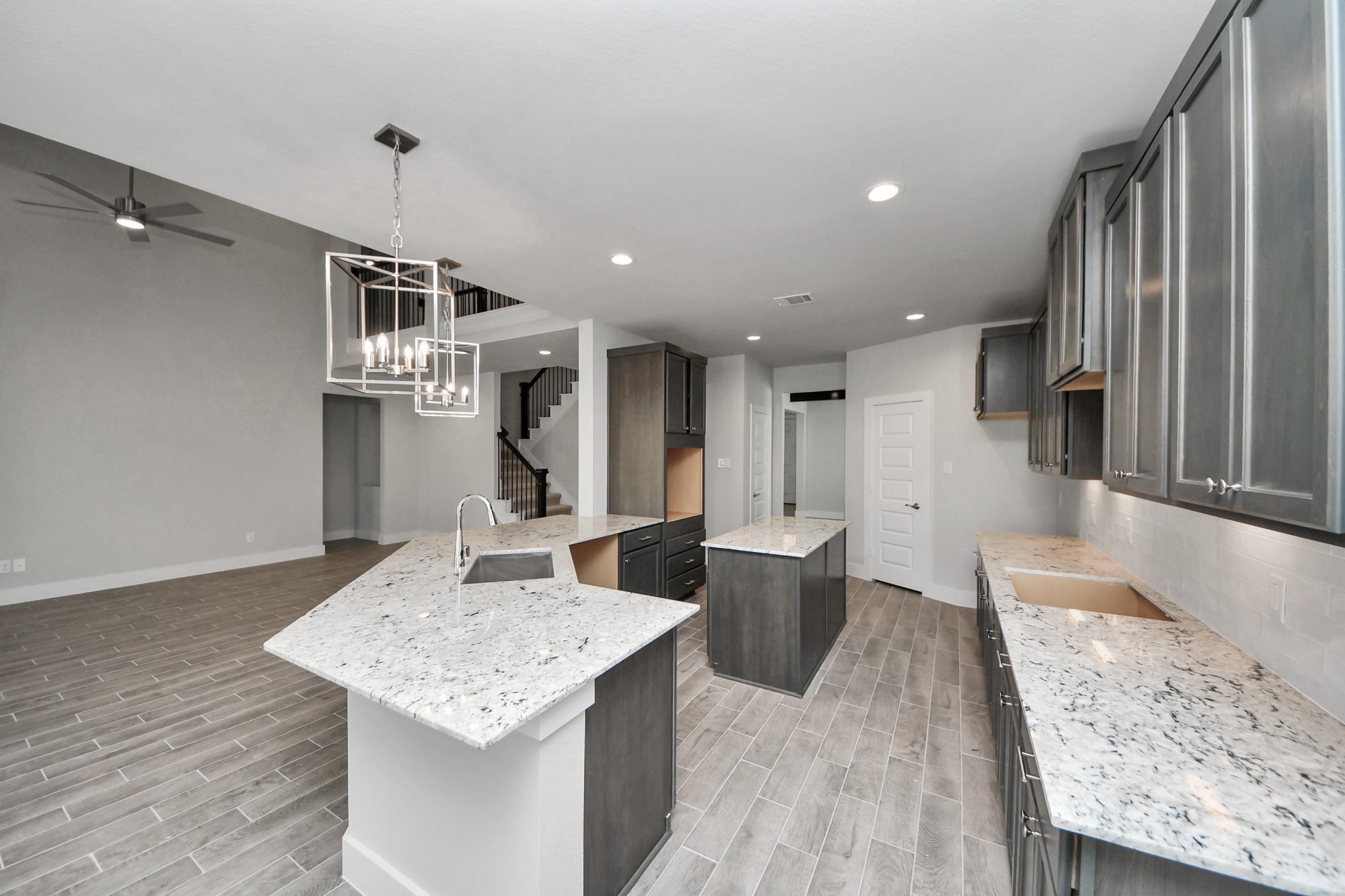 All of this overlooks your expansive family room, creating a perfect space for culinary delights and family gatherings. Sample photo of completed home with similar floor plan. Actual colors and selections may vary.