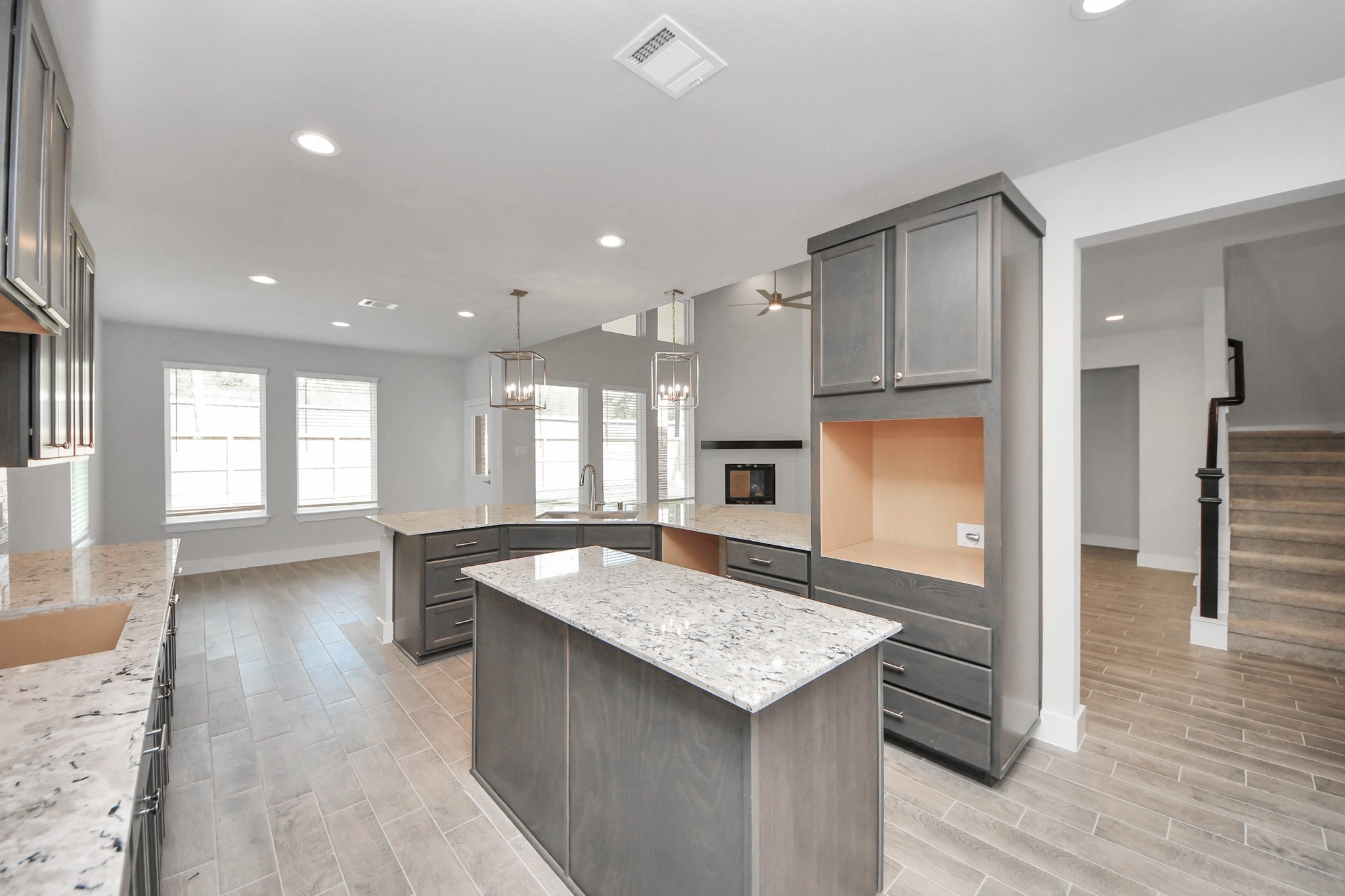 This generously spacious kitchen is a dream realized! With a massive granite island, high ceilings, soft close cabinets, granite countertops, stainless steel appliances, a sleek tile backsplash, recessed lighting, and an extended counter area, it offers both style and practicality. All this opens up to the expansive family room, creating a perfect hub for gatherings. Sample photo of completed home with similar floor plan. Actual colors and selections may vary. This generously spacious kitchen is a dream realized! With a massive granite island, high ceilings, soft close cabinets, granite countertops, stainless steel appliances, a sleek tile backsplash, recessed lighting, and an extended counter area, it offers both style and practicality. All this opens up to the expansive family room, creating a perfect hub for gatherings. Sample photo of completed home with similar floor plan. Actual colors and selections may vary.
