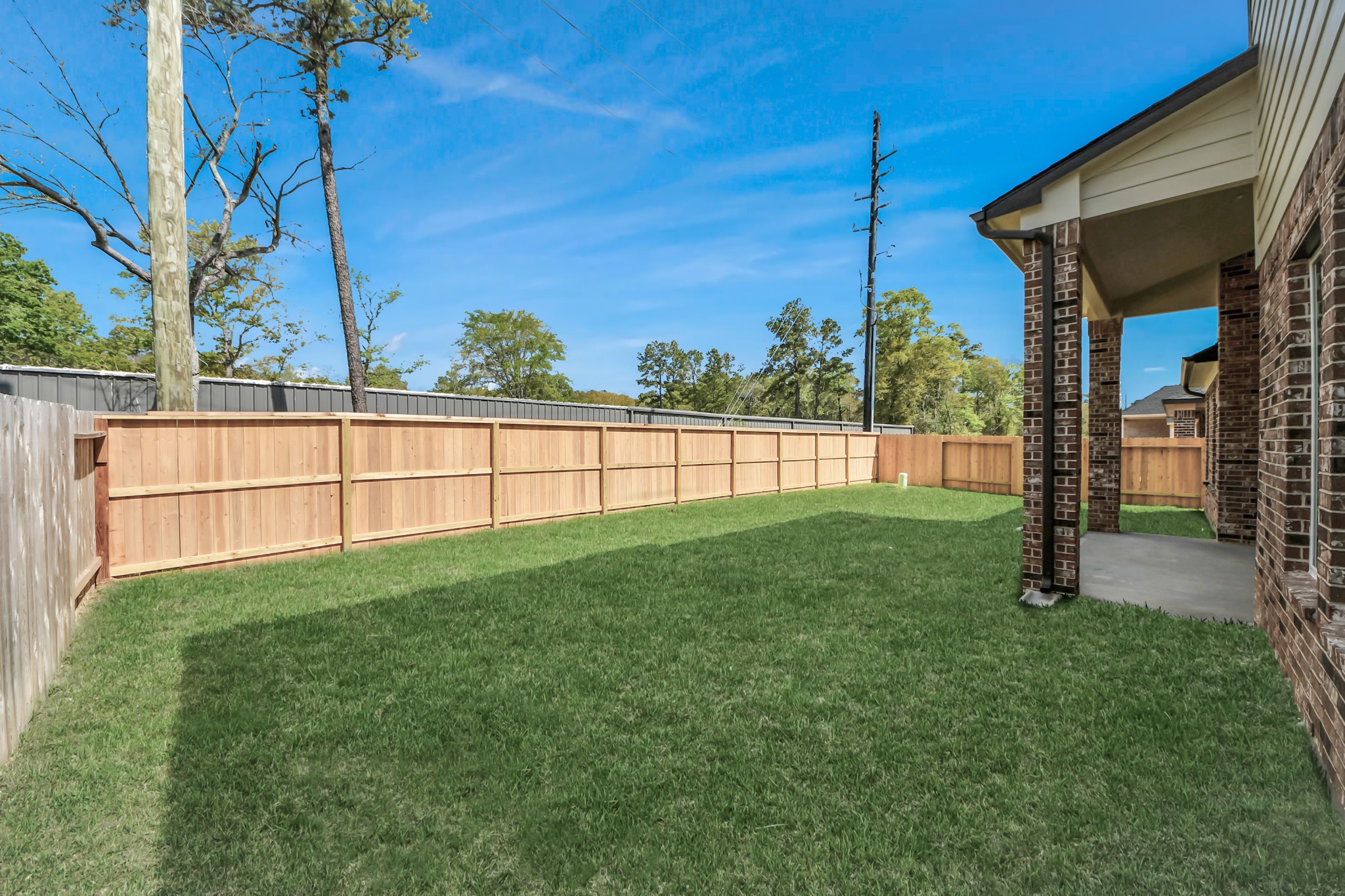 Experience outdoor living at its finest on this expansive covered patio, thoughtfully designed for BBQs and delightful outdoor dining. Sample photo of completed home with similar floor plan. Actual colors and selections may vary.
