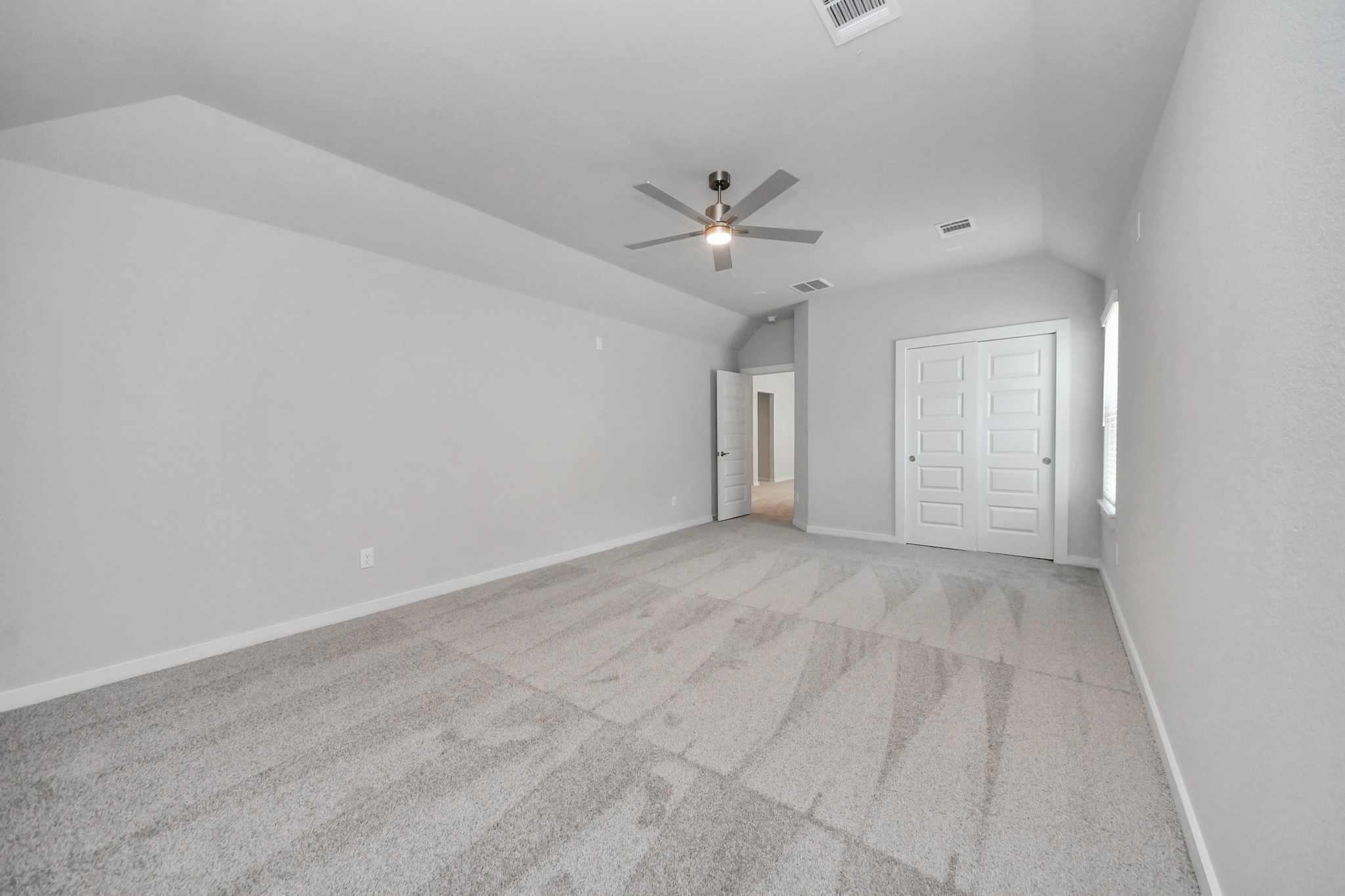 Generously sized secondary bedrooms featuring spacious closets, soft and inviting carpeting underfoot, large windows allowing plenty of natural light, and the added touch of privacy blinds for your personal retreat. Sample photo of completed home with similar floor plan. Actual colors and selections may vary.