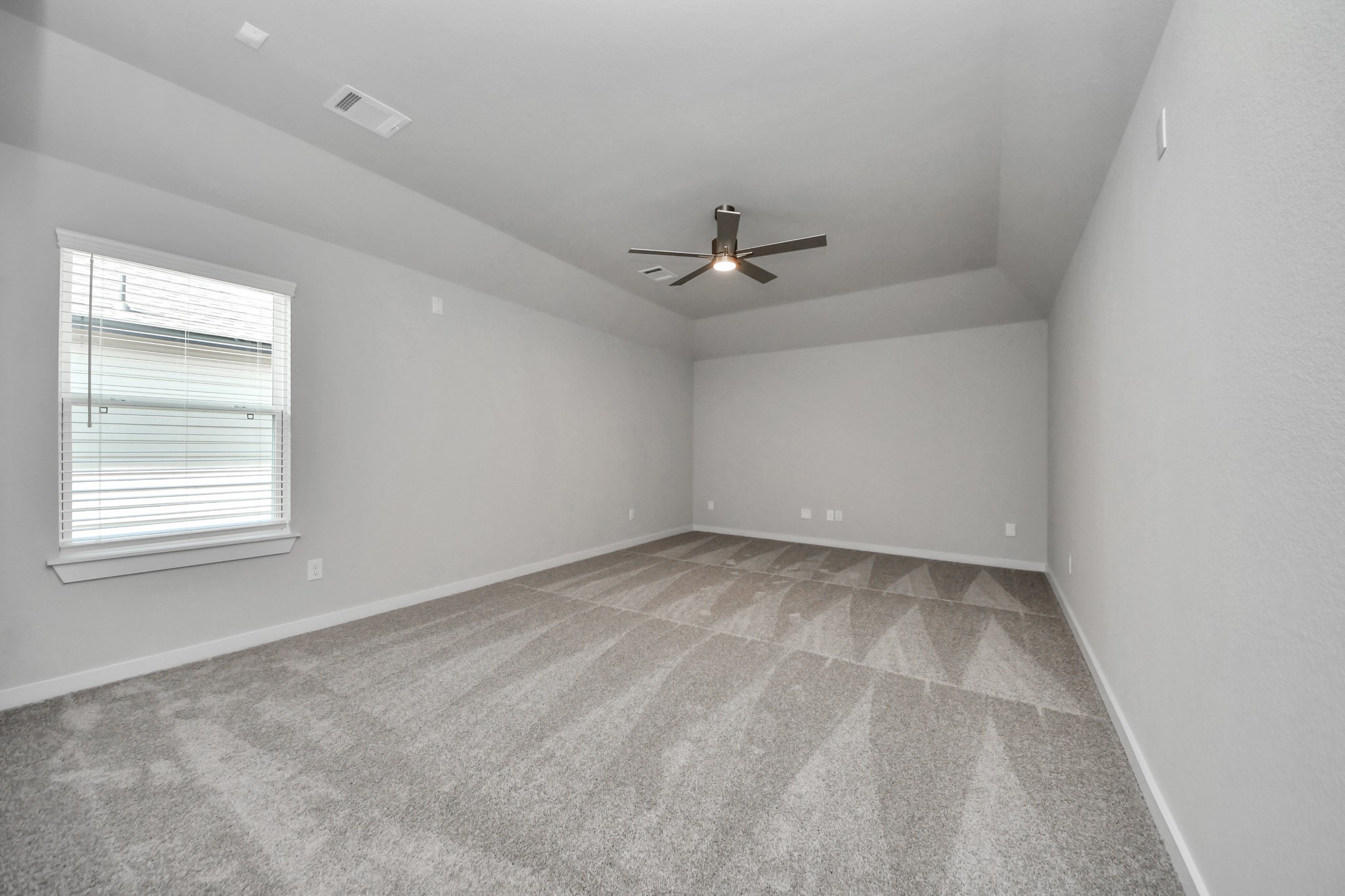 Secondary bedroom features plush carpeting, large windows that let in plenty of natural light, bright paint, and spacious closets. Sample photo of completed home with similar floor plan. Actual colors and selections may vary.
