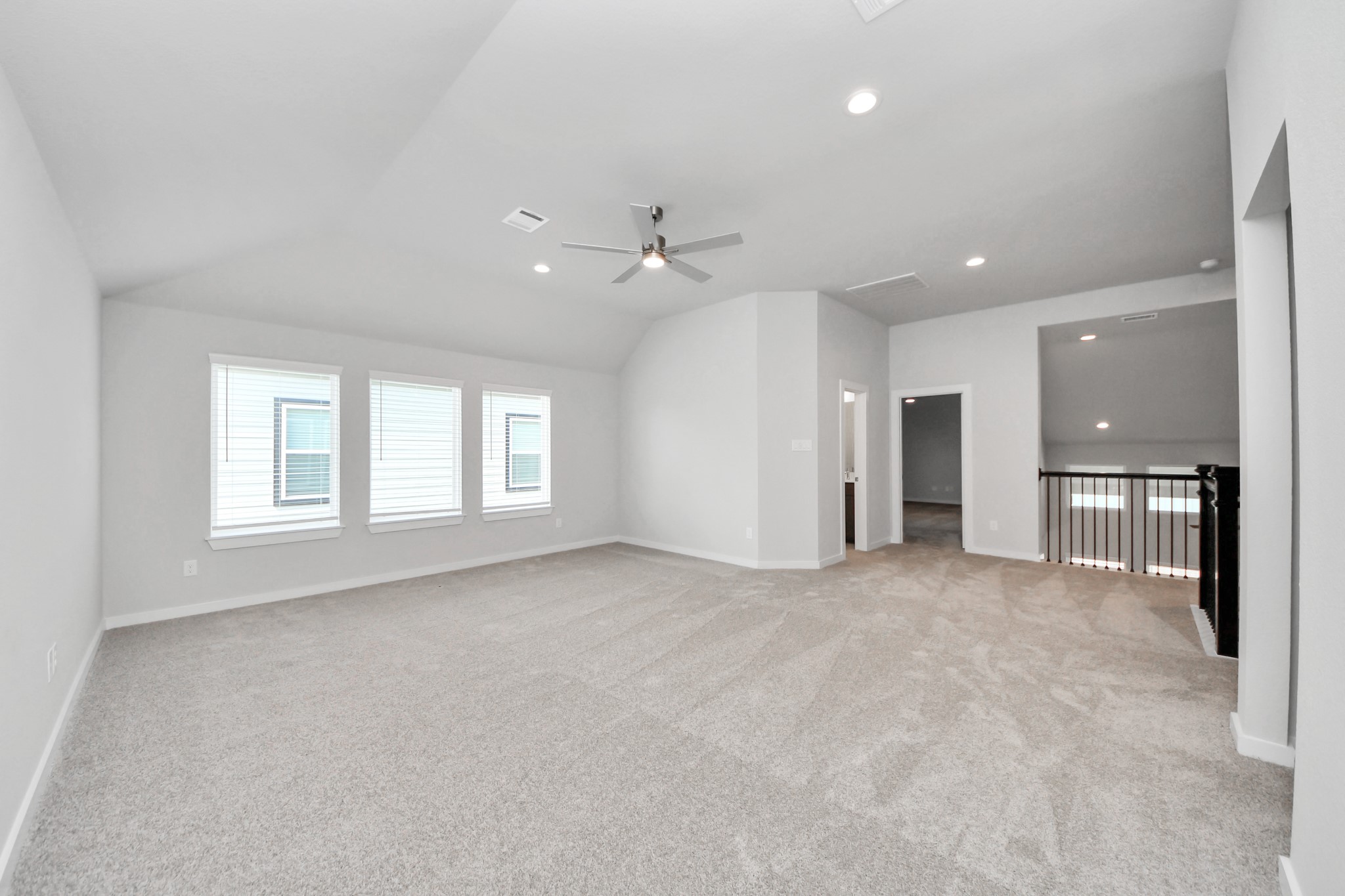 Ascend to relaxation in this fantastic game room! Ideal for both casual gatherings and adult gaming, it boasts plush carpet, lofty ceilings, custom paint, and ample windows for abundant natural light. Sample photo of completed home with similar floor plan. Actual colors and selections may vary.