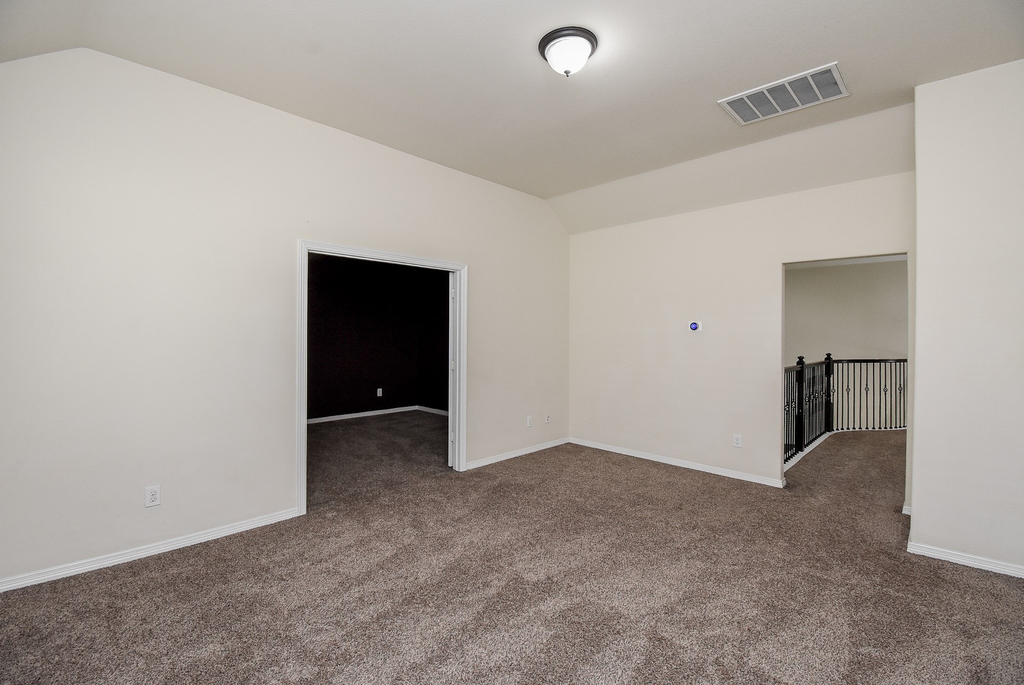 Alternate view of the game room looking towards the media room and the walkway towards the staircase.