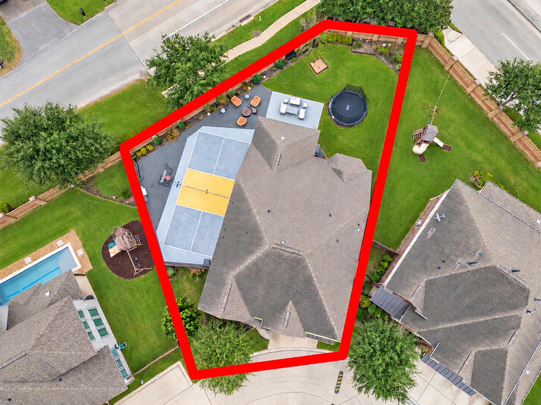 Enjoy your own private recreation retreat in this spacious backyard, featuring a screened-in covered patio, a multipurpose pickleball or basketball court, an expanded patio, and plenty of green space for outdoor fun and entertaining!