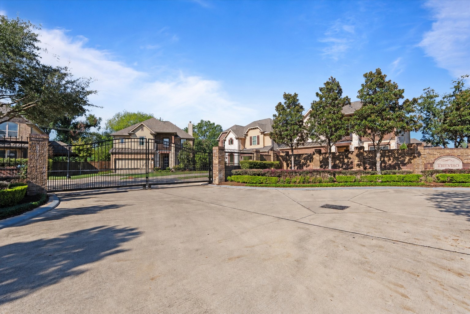 Gated community of just 17 homes in Spring Branch. An elegant wrought-iron entry gate, brick perimeter walls, and landscaped grounds create an inviting first impression.