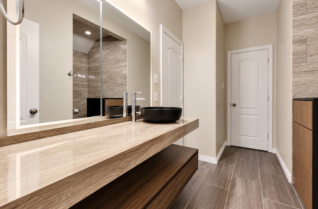 Fully renovated upstairs Jack-and-Jill bathroom featuring updated finishes, a walk-in shower, and convenient access from both adjoining bedrooms, combining style with everyday functionality.