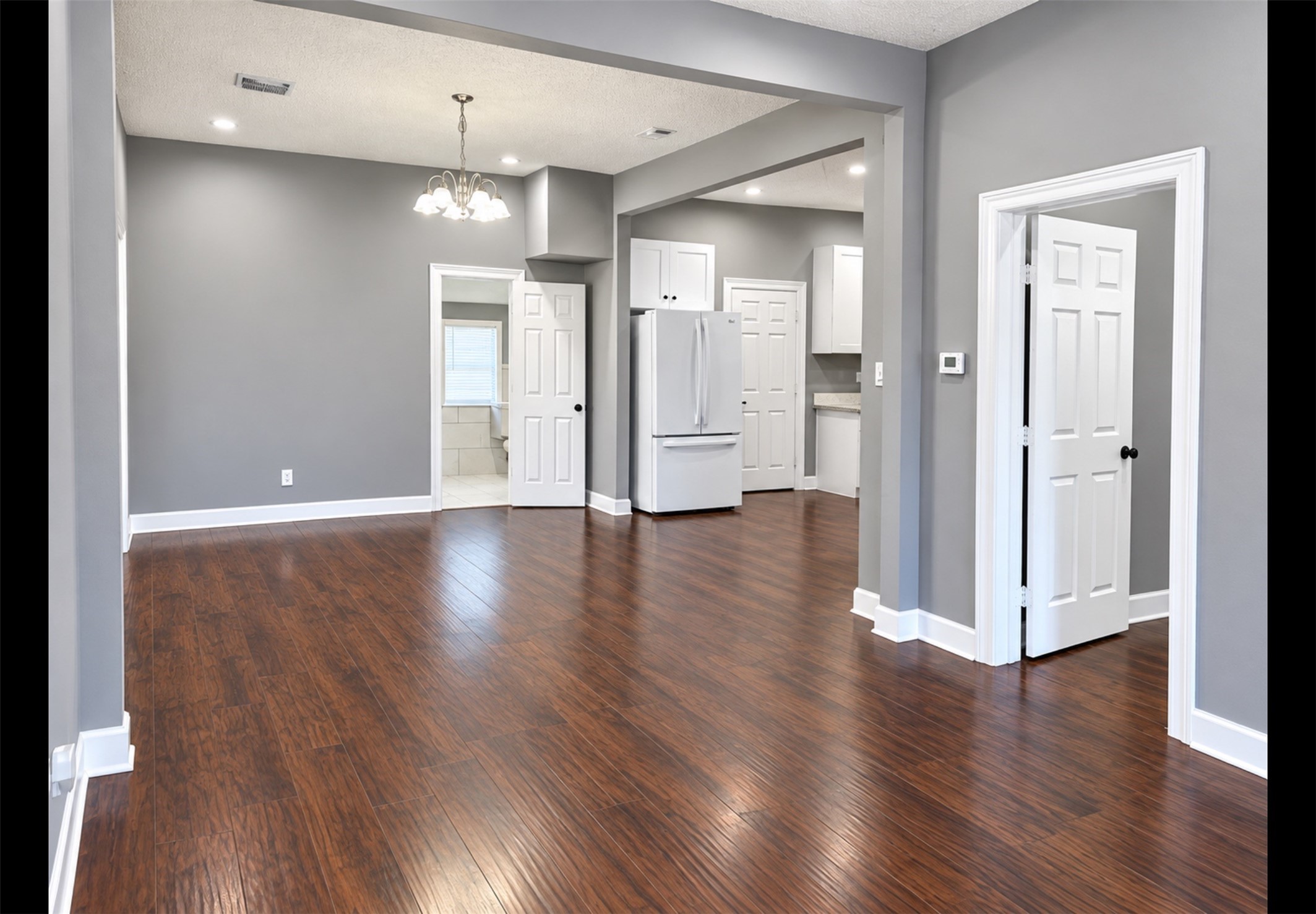 Spacious living area with nice laminate wood floors throughout.