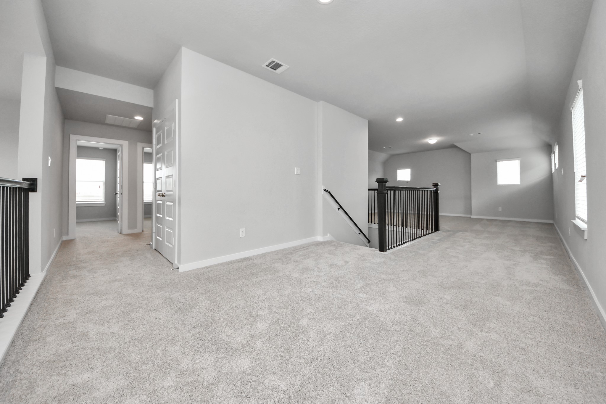 Come upstairs and enjoy a day of leisure in this fabulous game room! This is the perfect hangout spot or adult game room! Features plush carpet, high ceilings, custom paint and windows for plenty of natural light. Sample photo of completed home with similar floor plan. Actual colors and selections may vary.