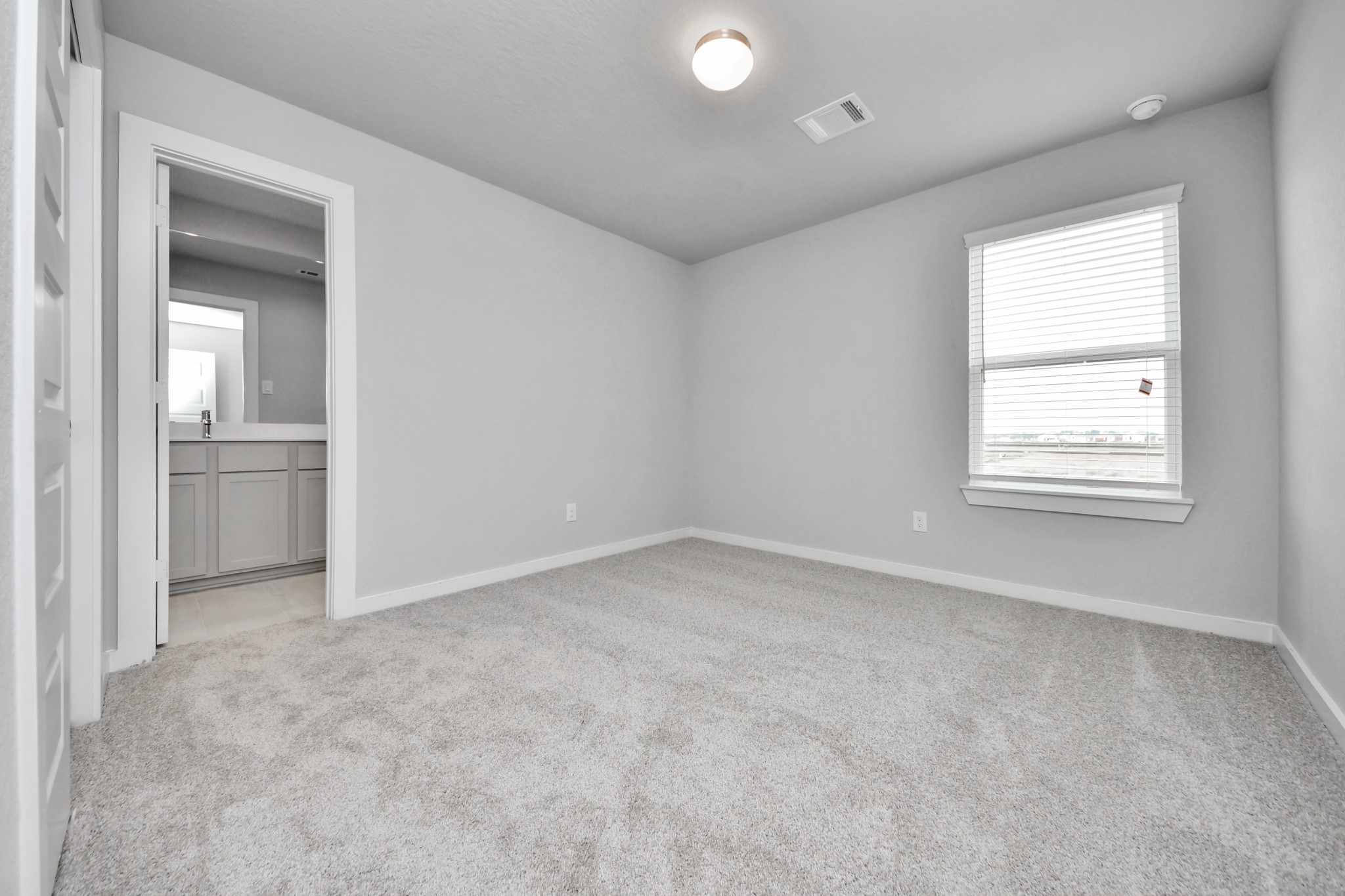 Generously sized secondary bedrooms featuring spacious closets, soft and inviting carpeting underfoot, large windows allowing plenty of natural light, and the added touch of privacy blinds for your personal retreat. Sample photo of completed home with similar floor plan. Actual colors and selections may vary.