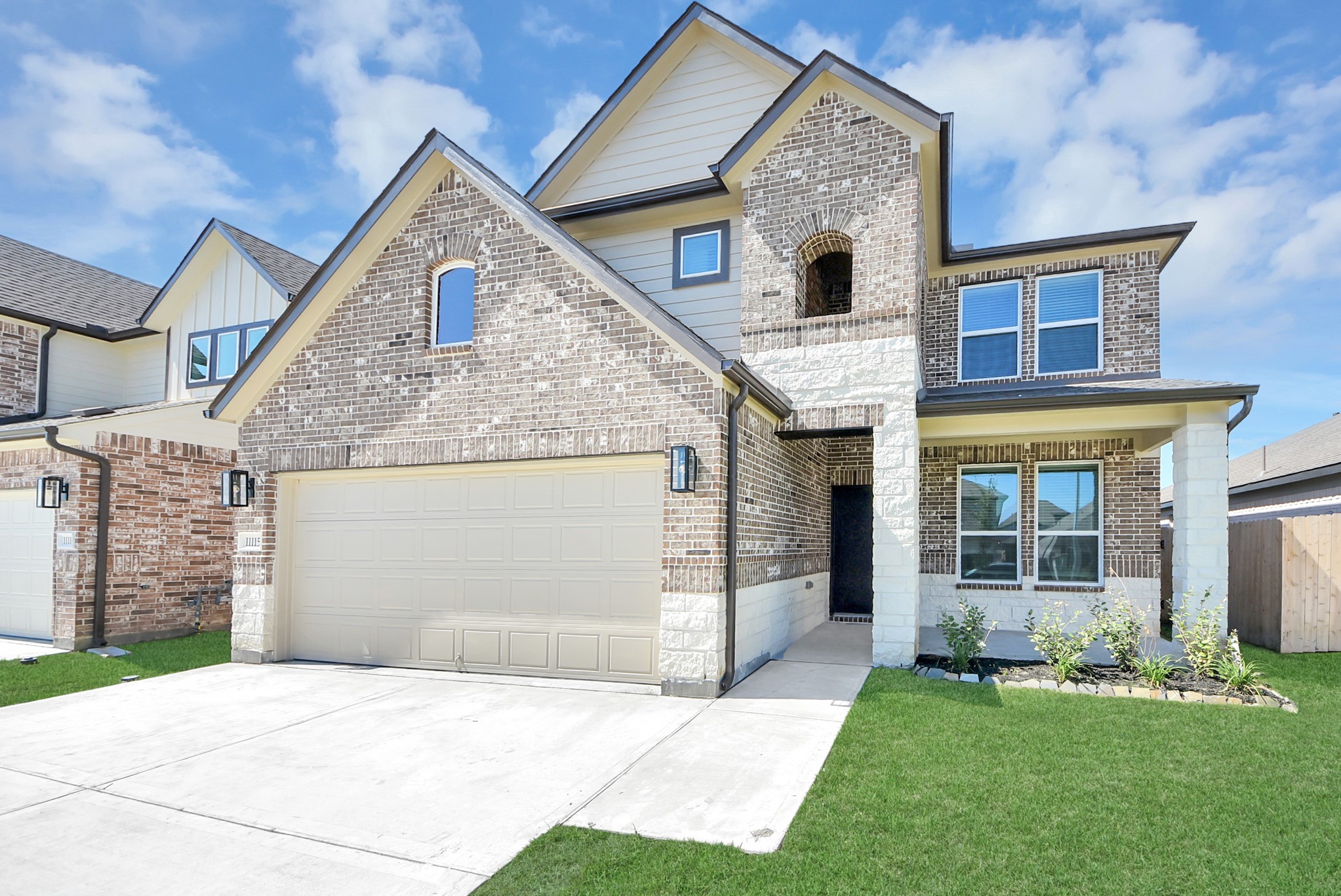 The residence features a practical 2-car garage complemented by a generous driveway, ensuring abundant space for parking needs.
