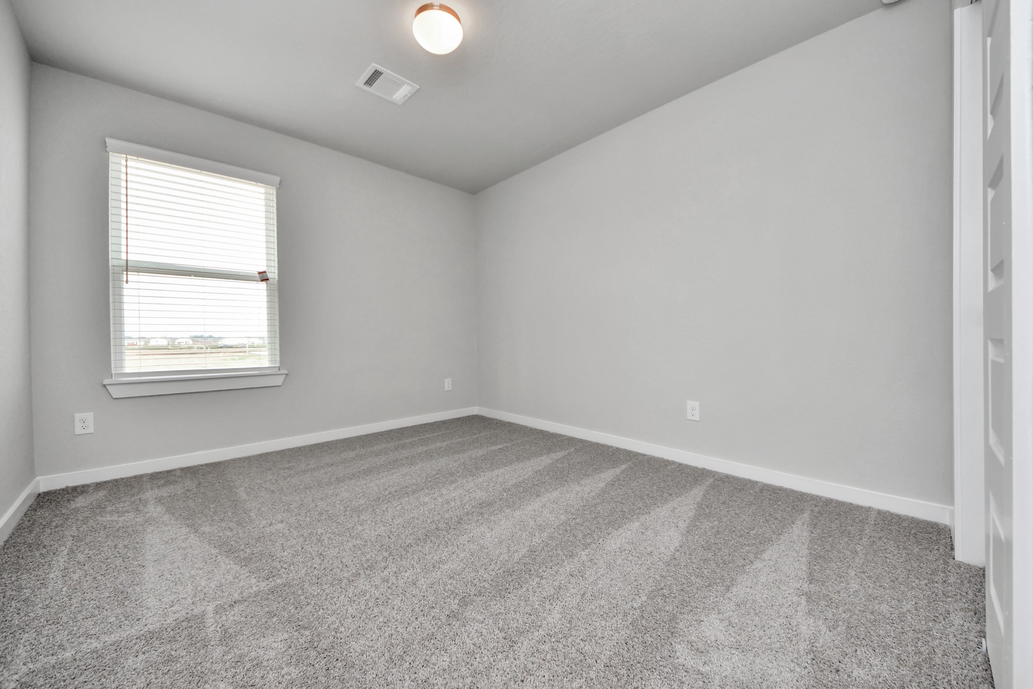 Generously sized secondary bedrooms featuring spacious closets, soft and inviting carpeting underfoot, large windows allowing plenty of natural light, and the added touch of privacy blinds for your personal retreat. Sample photo of completed home with similar floor plan. Actual colors and selections may vary.