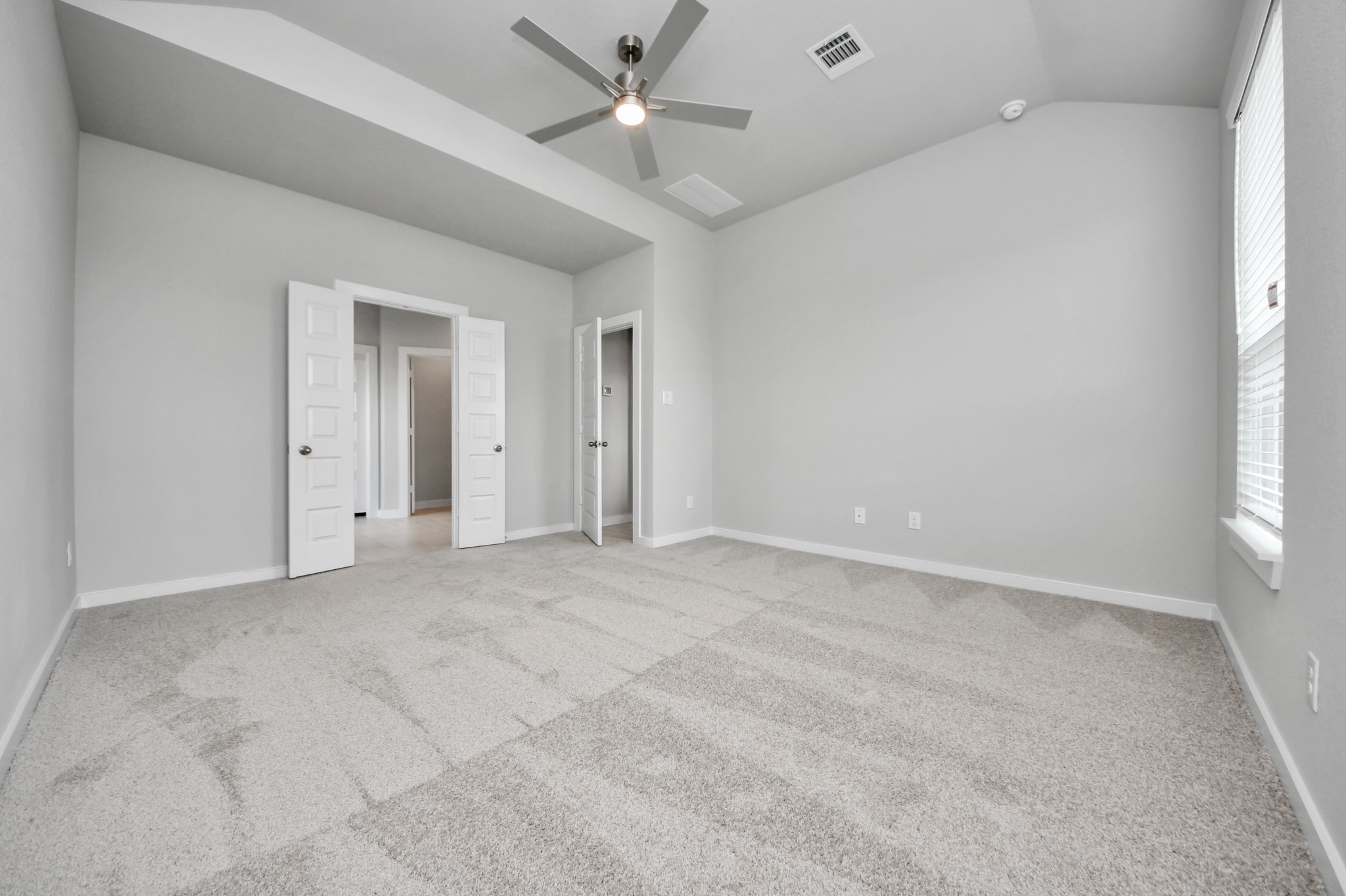 Come and unwind after a long day in this magnificent primary suite! This spacious room features plush carpet, warm paint, high ceilings and large windows with privacy blinds. Sample photo of completed home with similar floor plan. Actual colors and selections may vary.